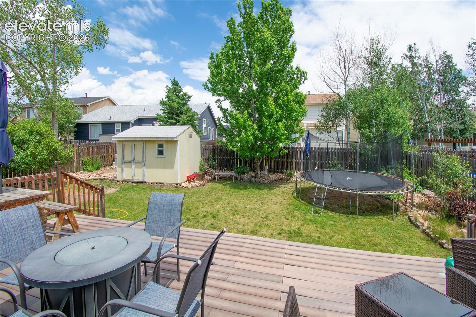 Fully fenced back yard and a shed for storage.