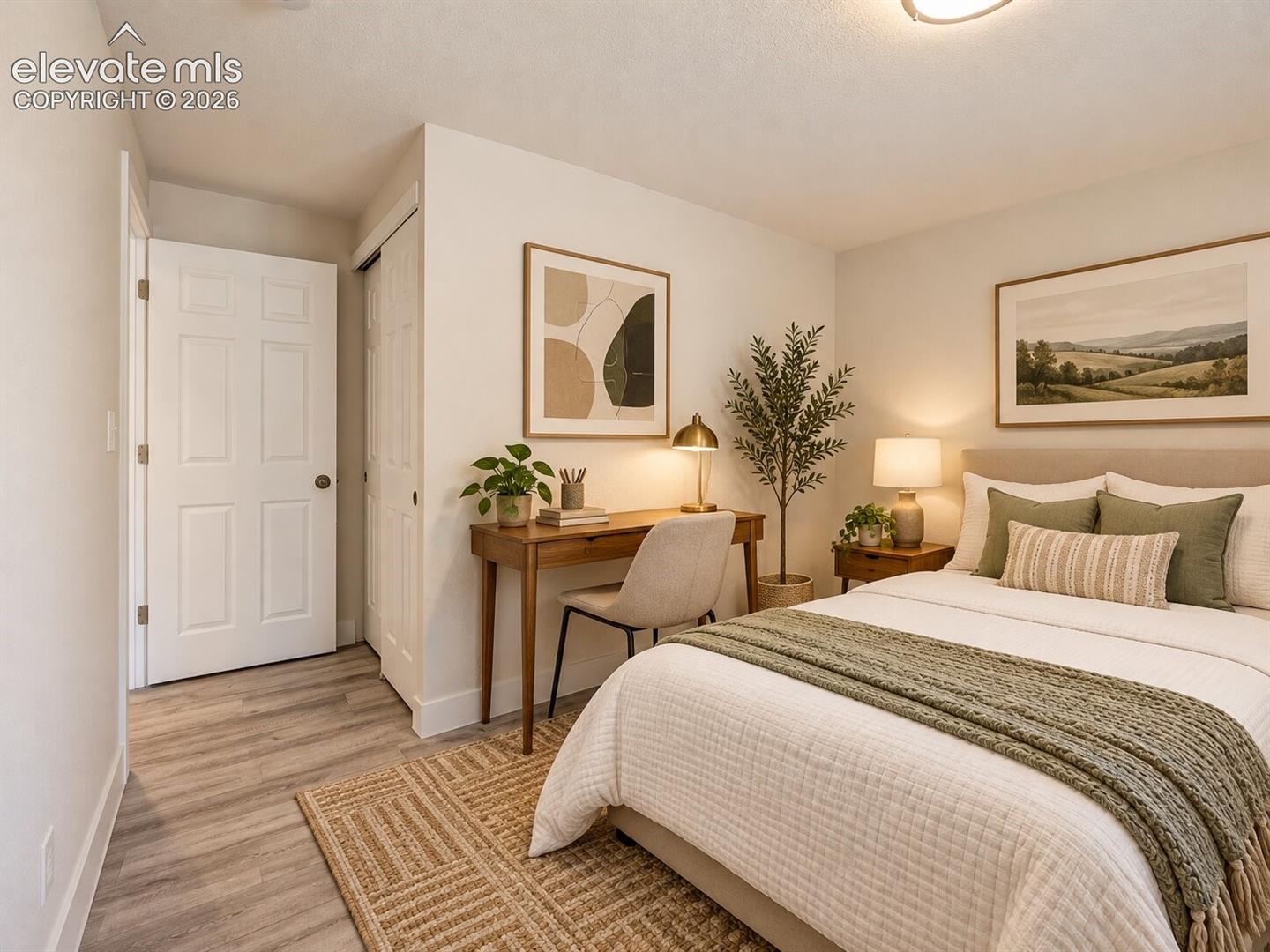 Neutral interior with wood-finish flooring, two-panel interior door, and sliding closet doors. AI-Enhanced – furniture/decor digitally added