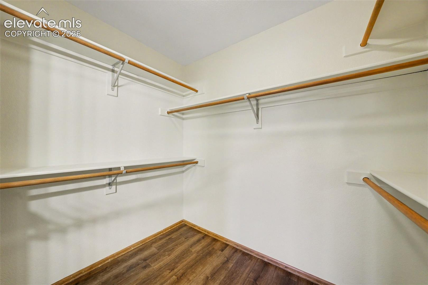 New LVP flooring with multiple built-in shelving units and hanging rods
