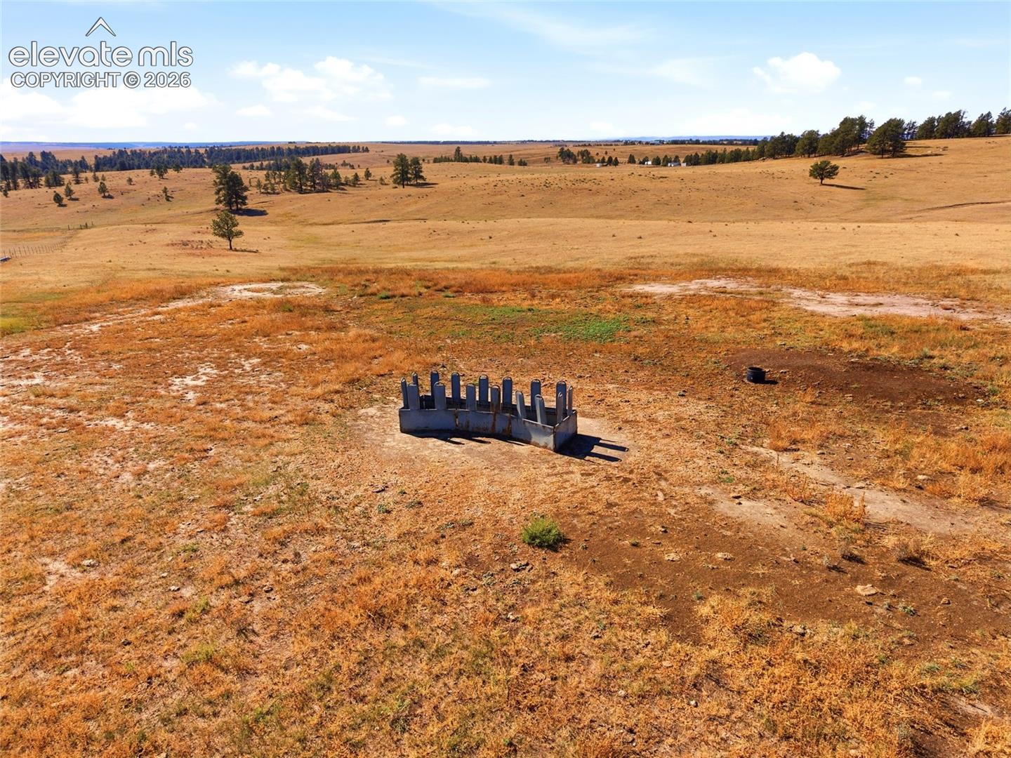 Expansive acreage featuring rolling terrain and a concrete foundation structure