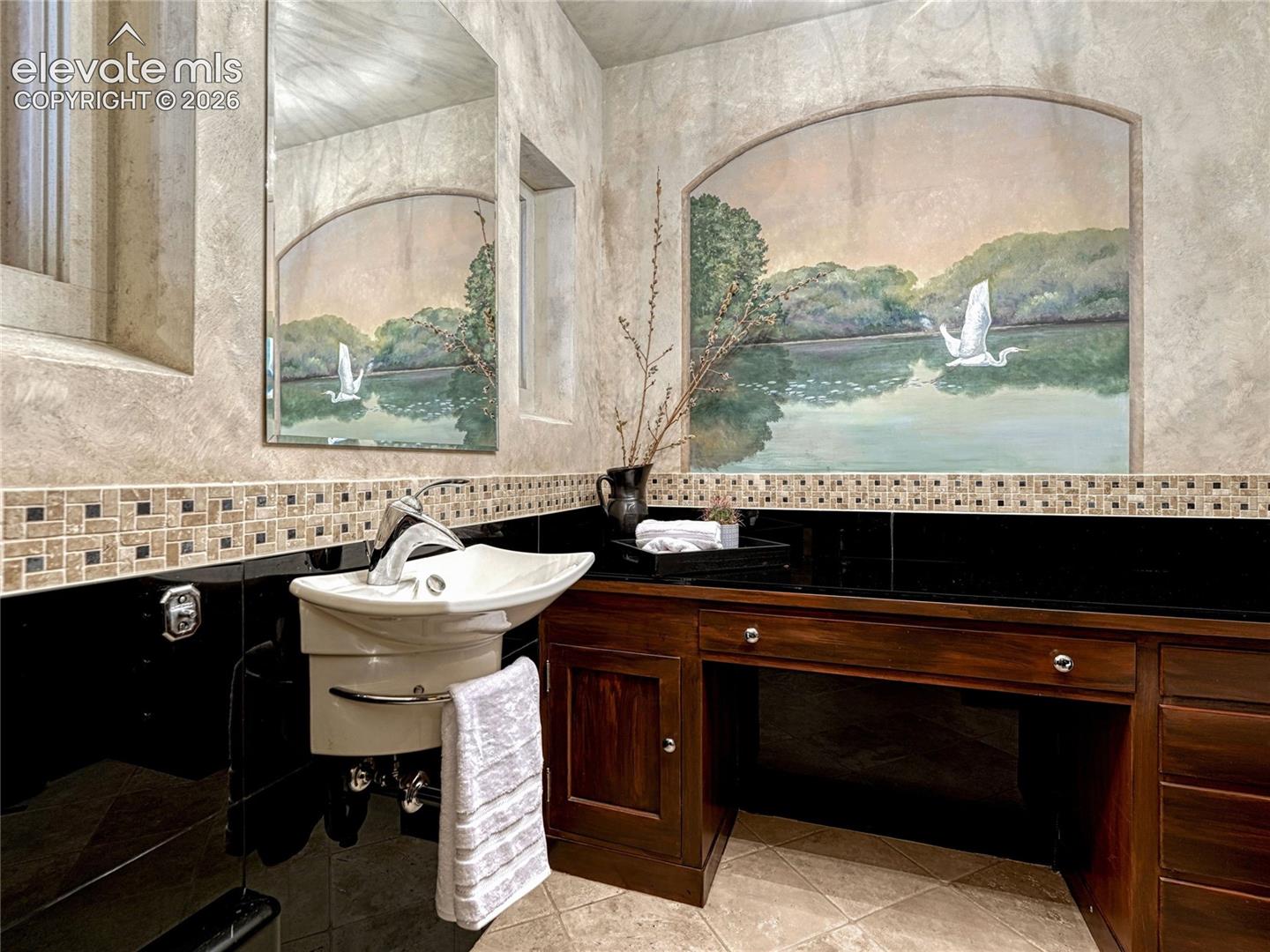 The Elvis Room | Main Level guest bath with original mural artwork.