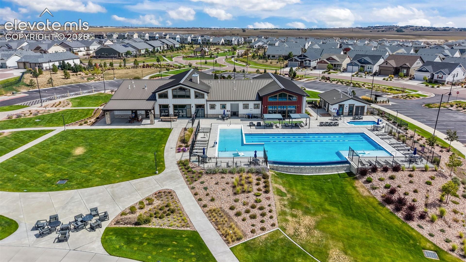 Community clubhouse, pool, hot tub, outdoor seating and concert area.