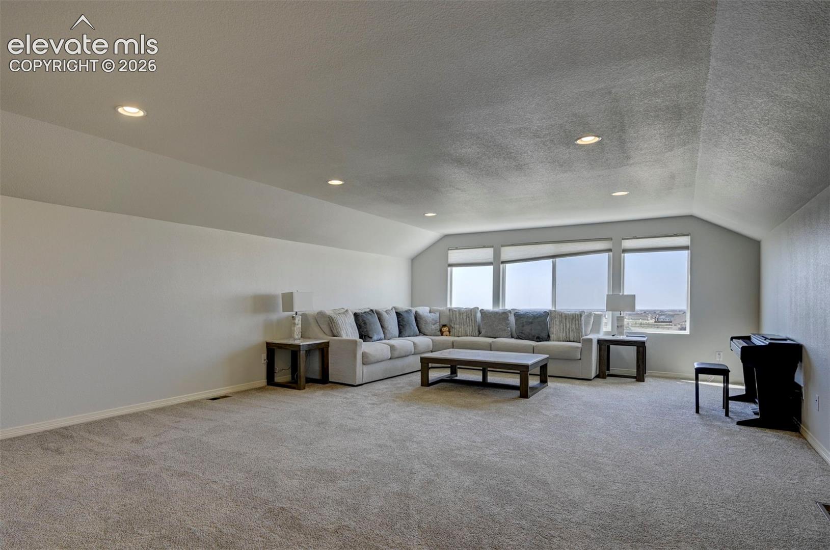 3rd Floor featuring broad windows with roller shades, recessed lighting, and sloped ceiling details, beautiful views