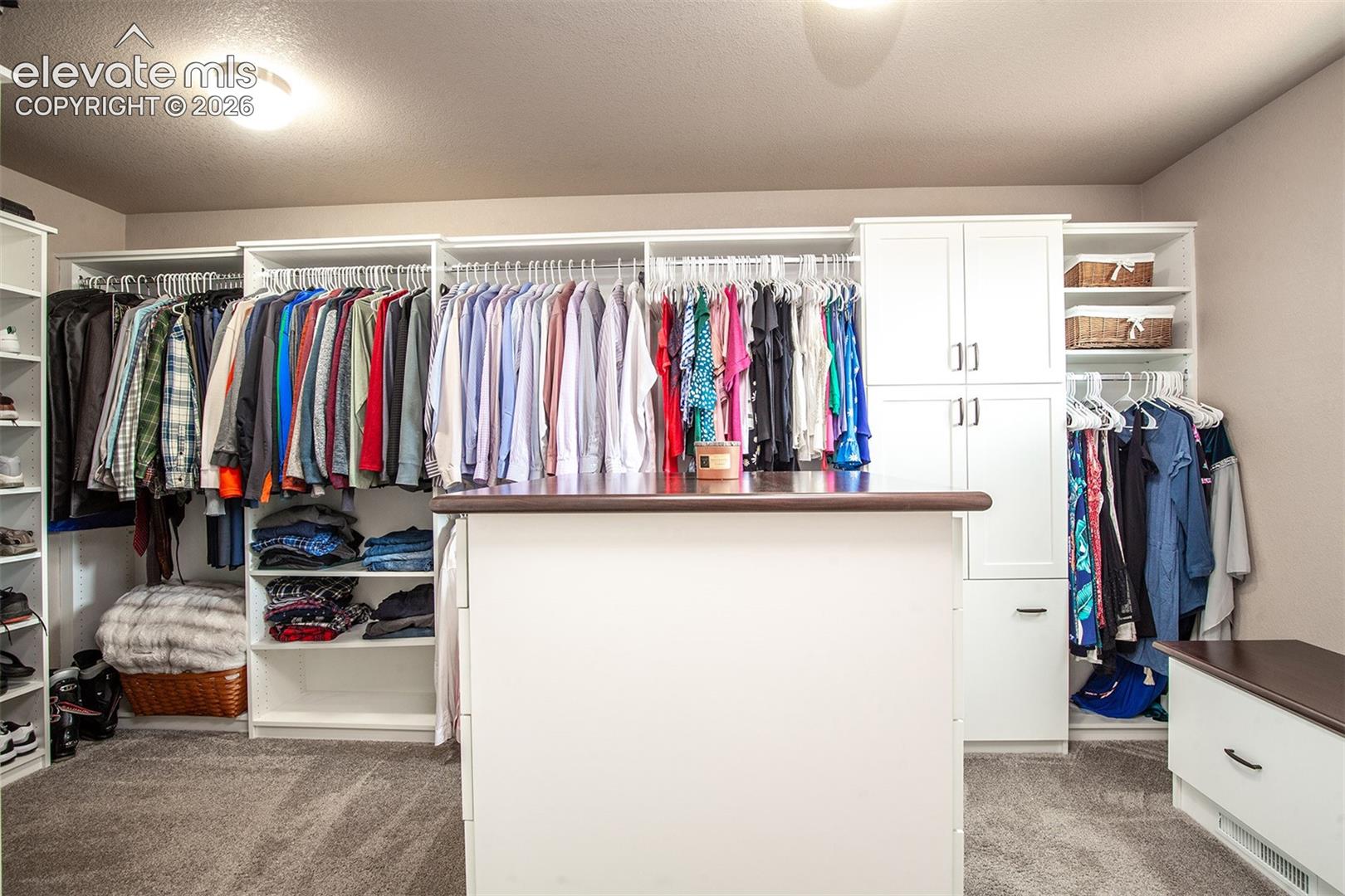 Enormous walk-in closet featuring custom built-ins from the Closet Factory