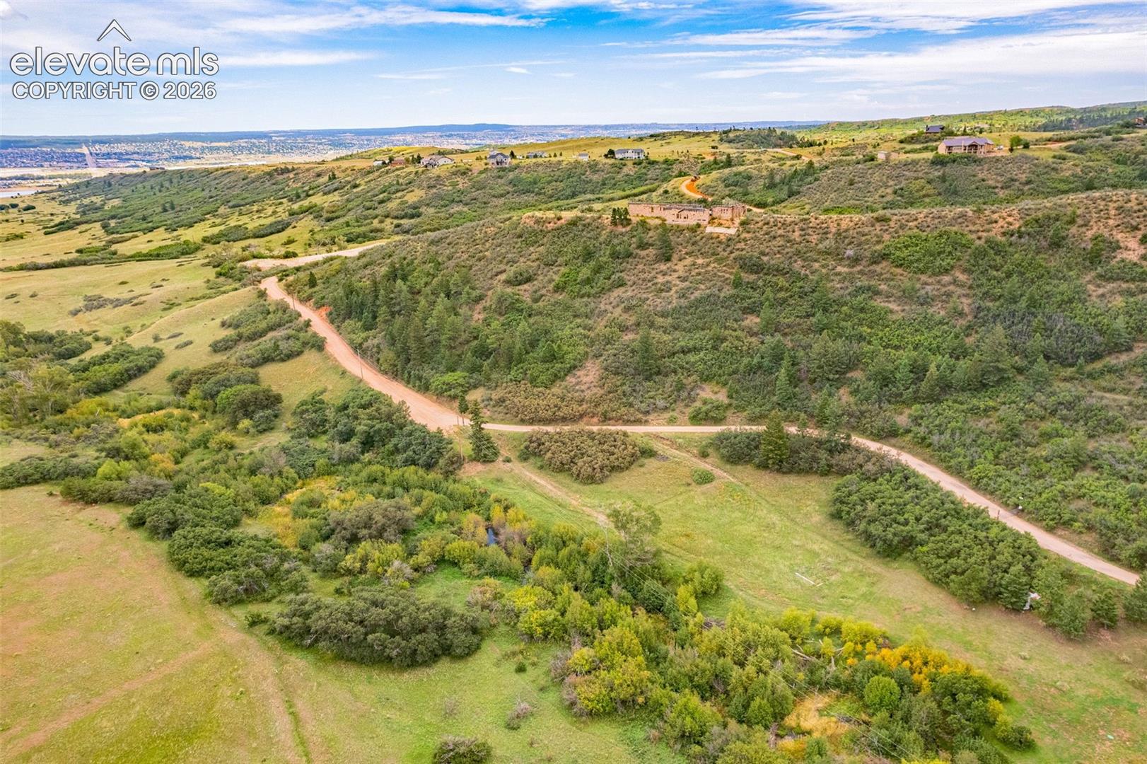 Expansive landscape featuring rolling hills and abundant natural foliage