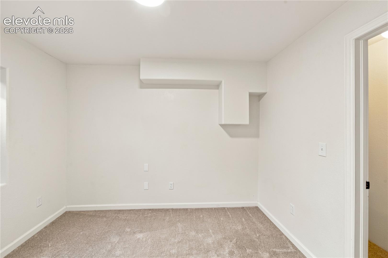 Bright interior space featuring a light neutral color palette, plush carpeting, and recessed lighting