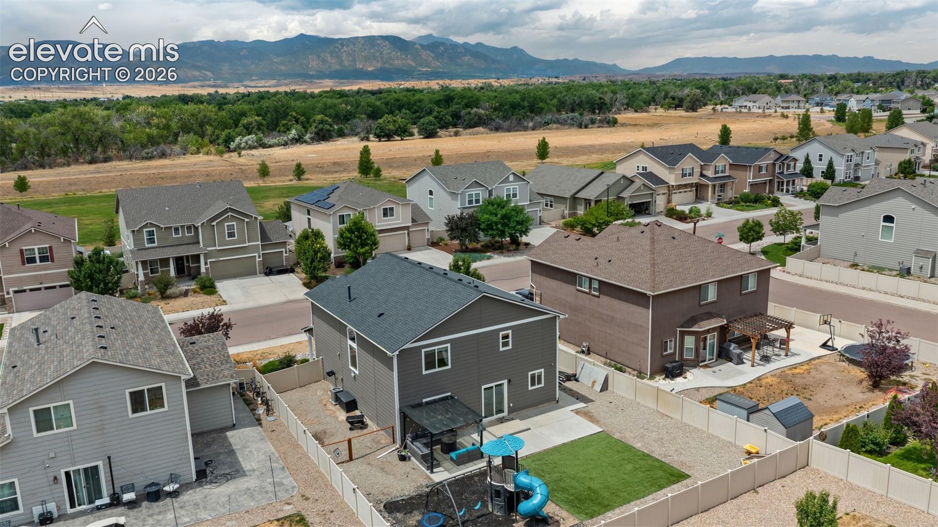 Aerial perspective showcasing a residential development with distant mountains