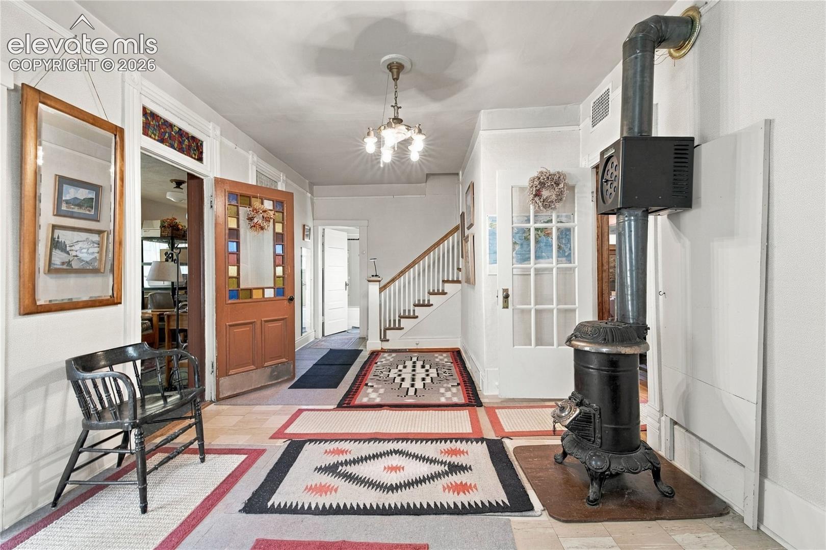 The front porch leads to a foyer and living room with sitting area and wood burning stove.