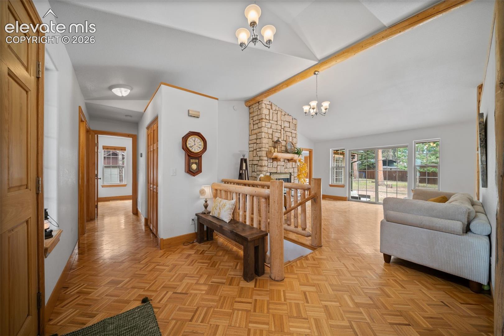 The entry is warm and inviting with natural wood floors, vaulted ceilings and rustic charm