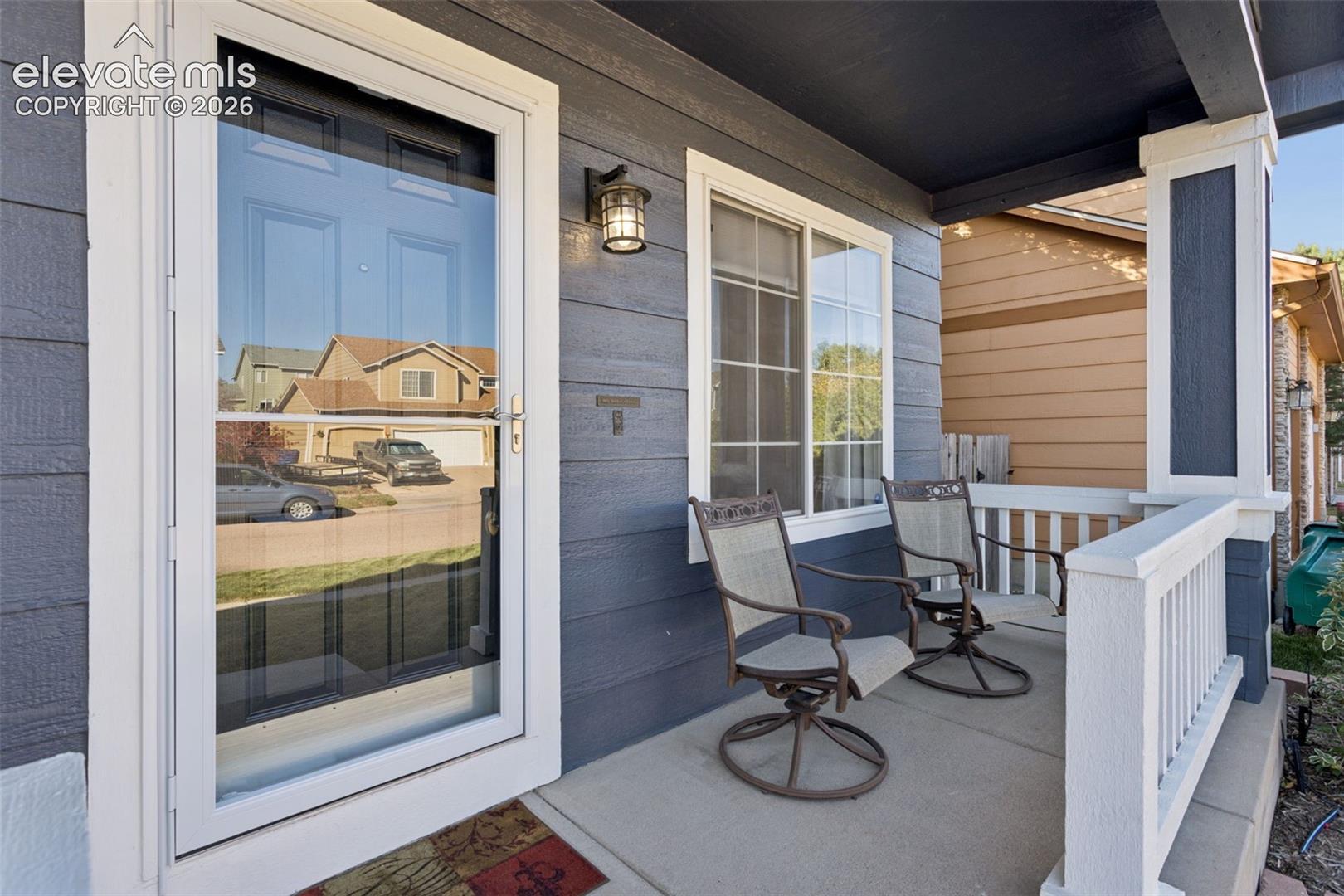 Expanded front covered porch, and front entry into home 