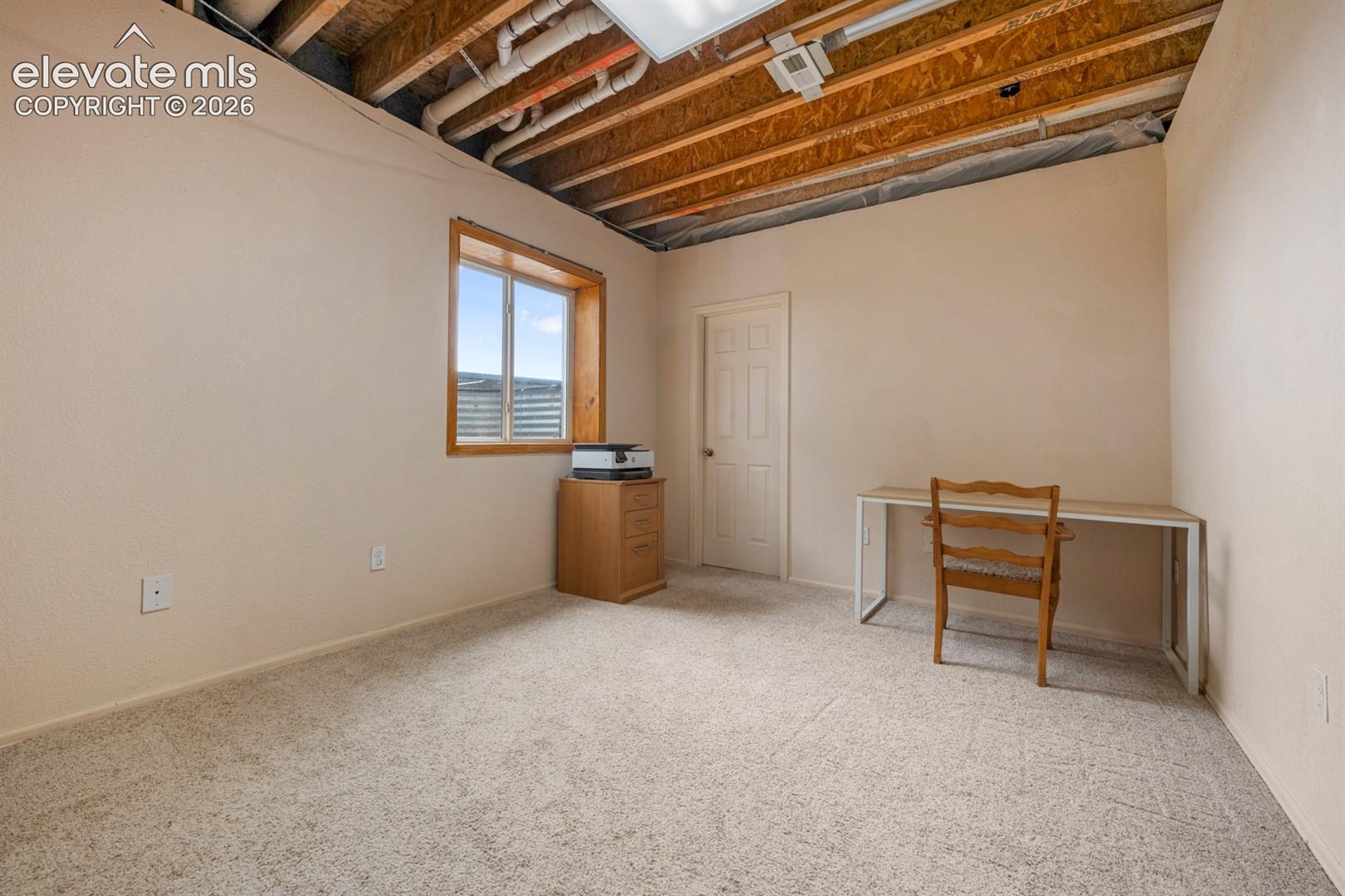 Bedroom at the back of the home garden level with walk in closet.