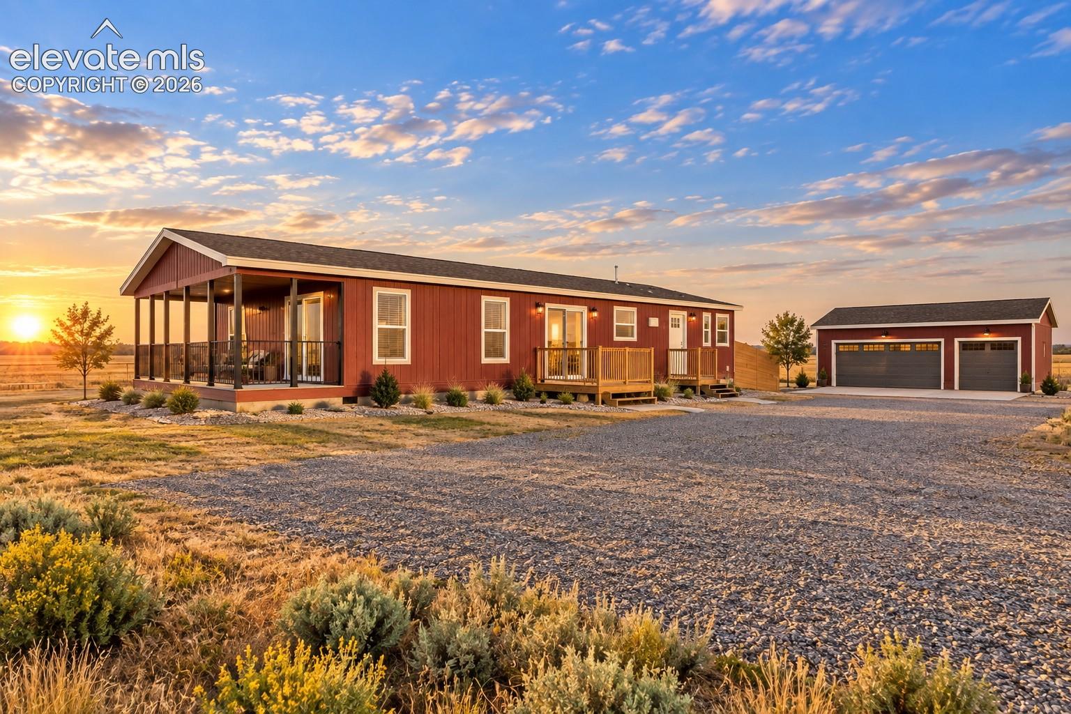 Detached Garage – Detached garage features two separate overhead doors, exterior lighting, and a concrete apron, providing substantial space for vehicle parking, storage, or workspace.