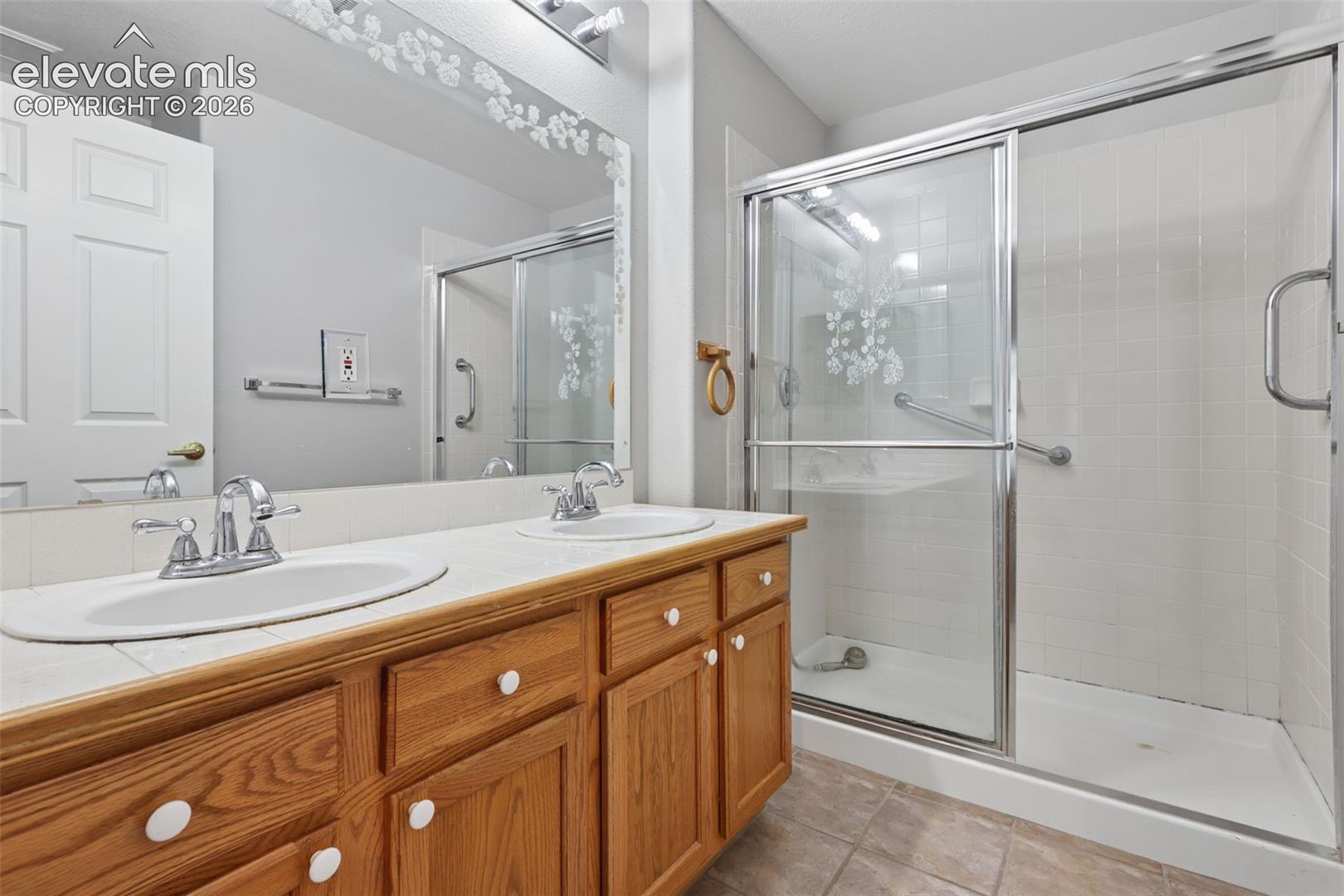 Dual vanity with wood-finish cabinetry