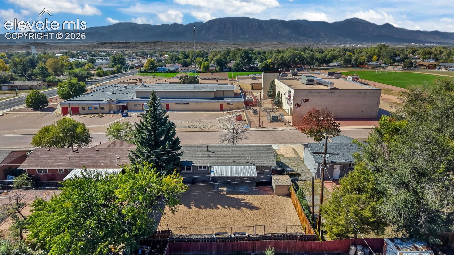 Expansive property lot featuring mature trees, a fenced perimeter, and a gravel surface