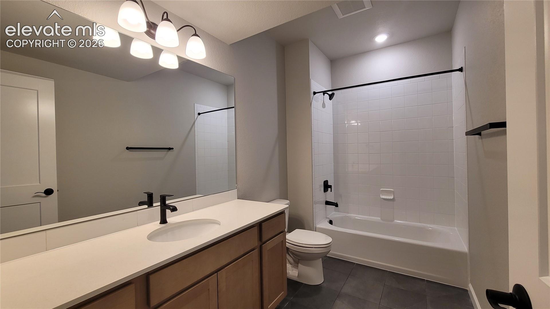 Full Bathroom with a linen closet, quartz countertops, and tile surrounds!