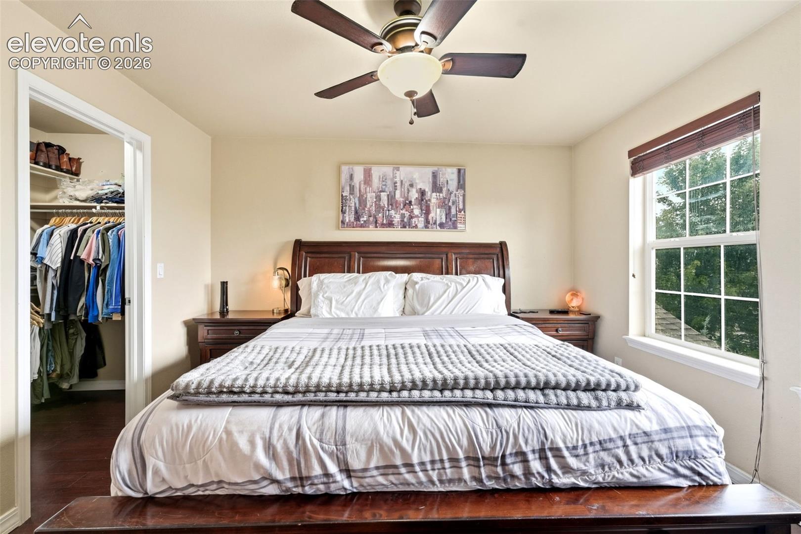 Recessed lighting, wood-finish flooring, built-in shelving, ceiling fan, and large window