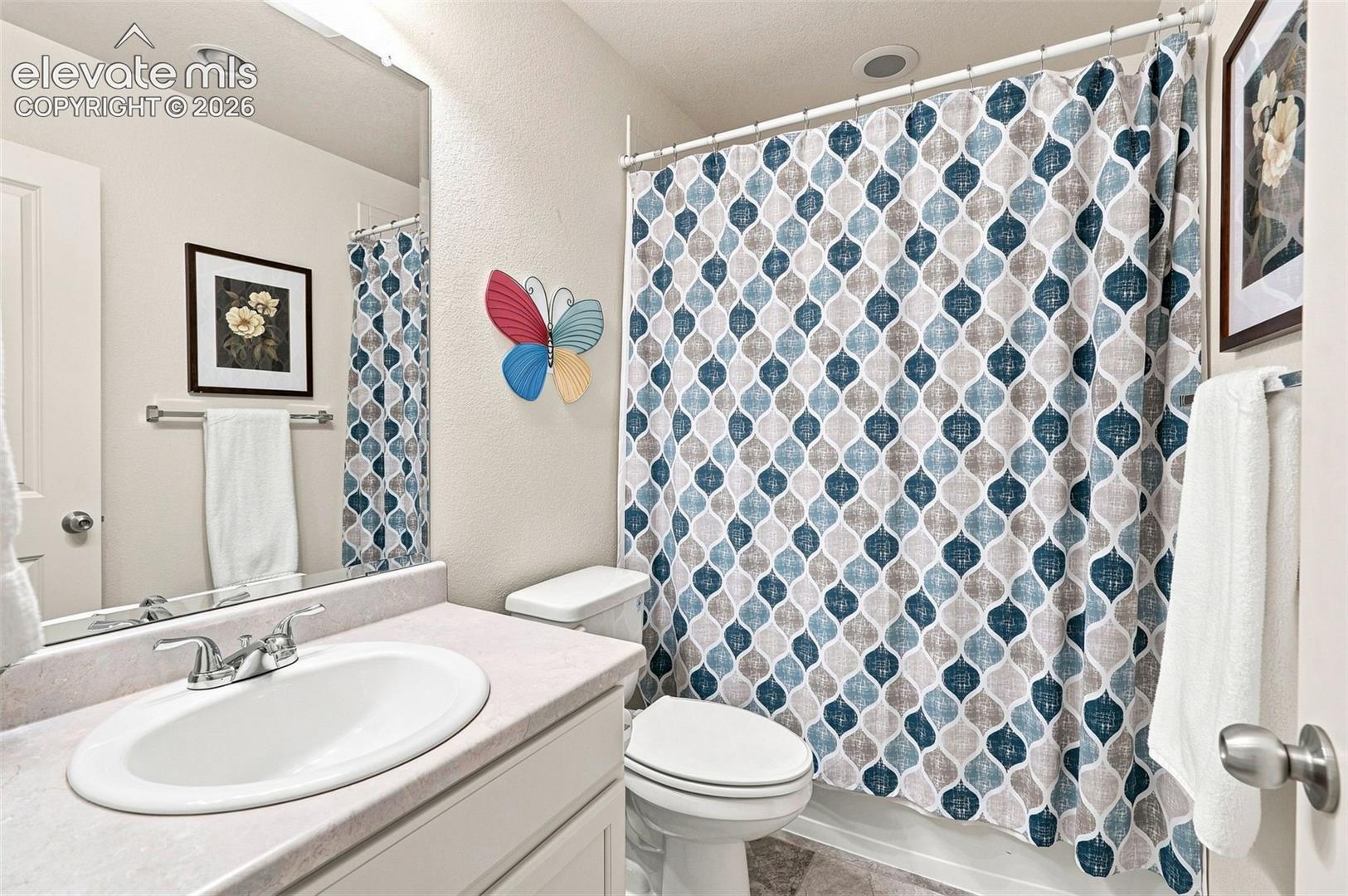 Full secondary bath off hall with tile floor