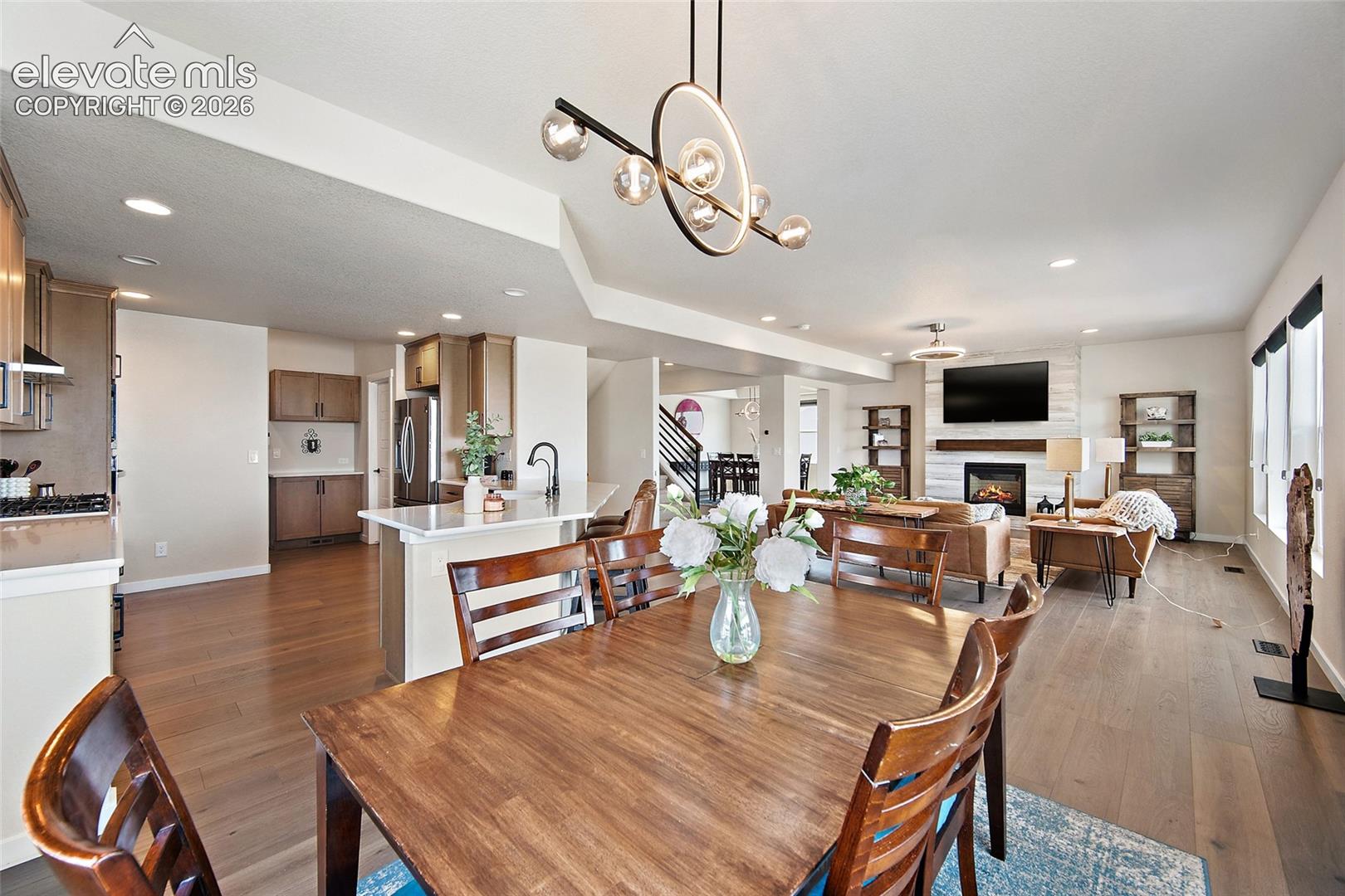 Open-concept living space with wood-finish flooring throughout