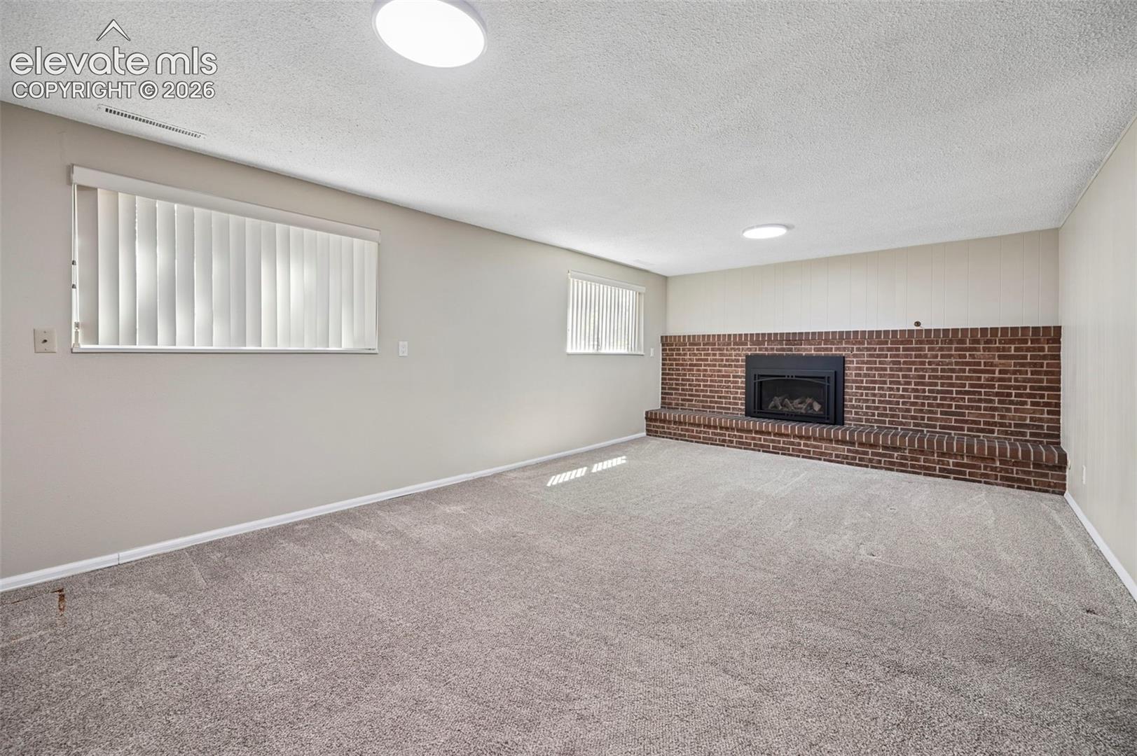 Bright, spacious Family room with wood burning Fireplace