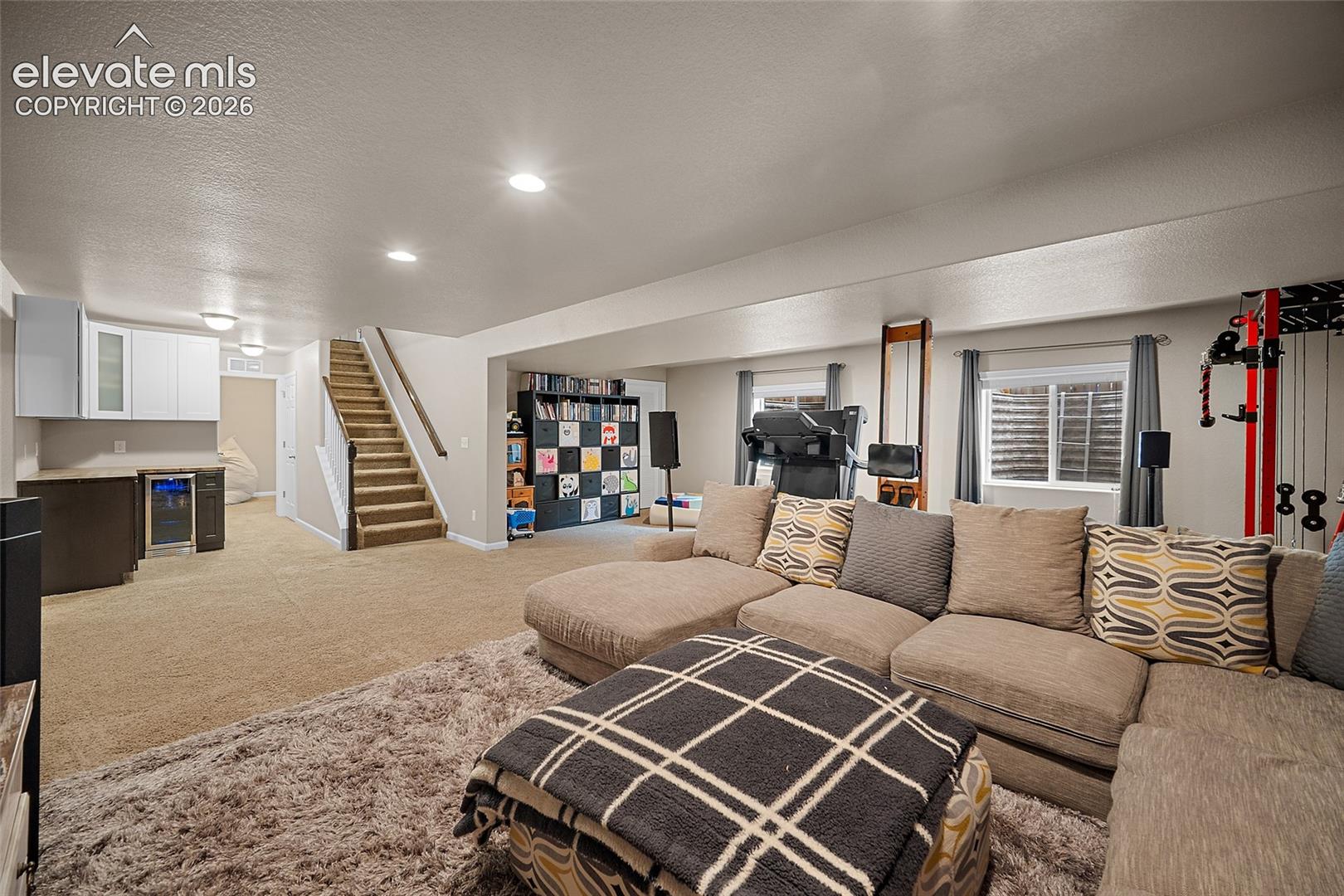 Fully finished basement with large flex space and dedicated storage room.