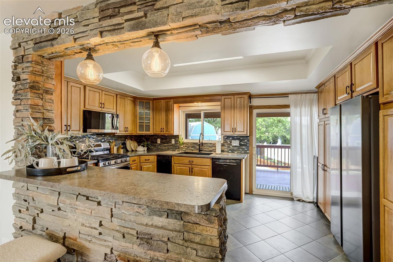Stacked stone accent wall leading into the kitchen. 