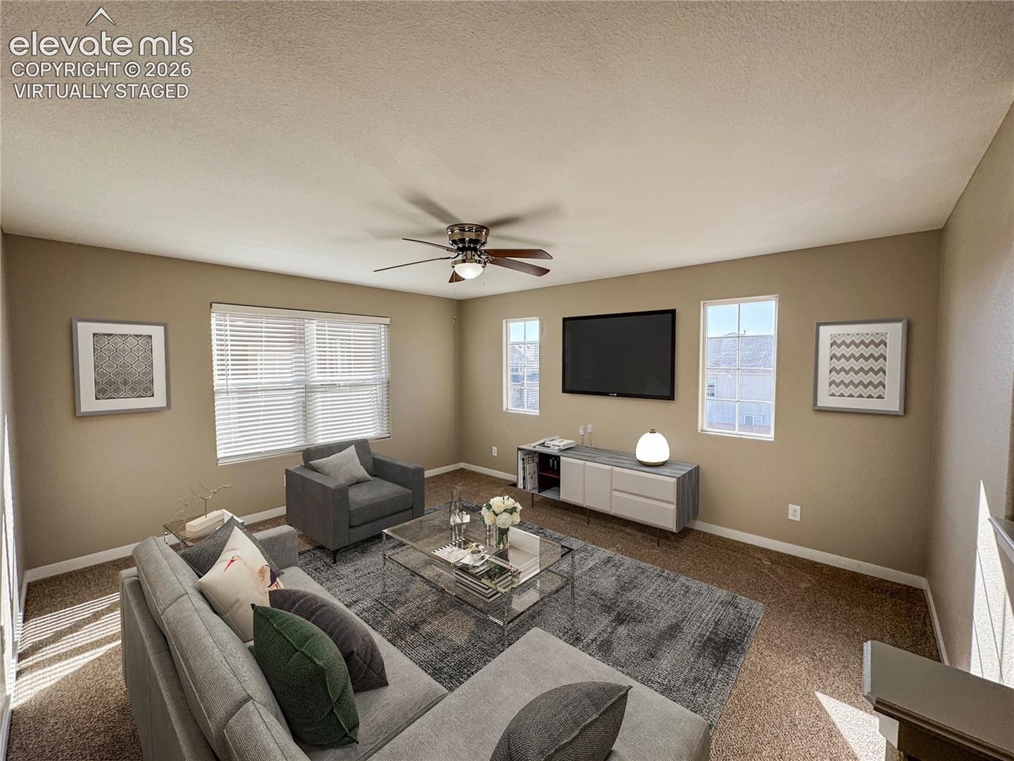 virtually staged Neutral-toned interior featuring wall-to-wall carpeting, multiple double-hung windows, and a ceiling fan with integrated lighting