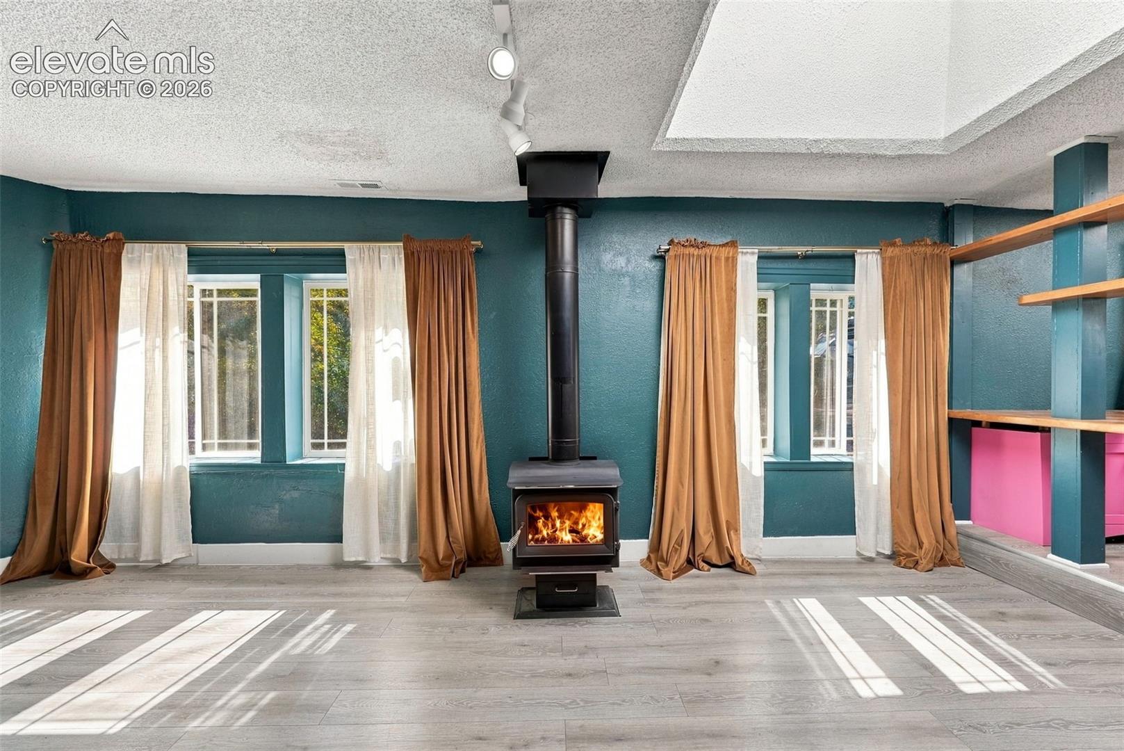 Wood-burning stove, built-in shelving, track lighting