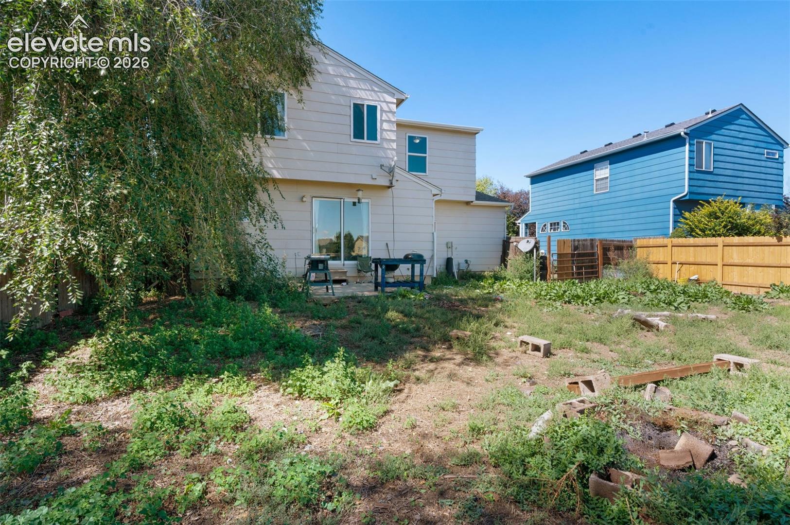 Rear exterior featuring siding construction and multiple windows