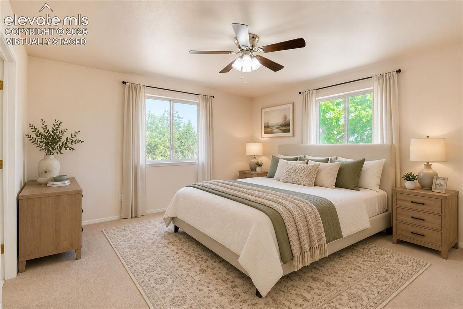 Neutral-toned bedroom featuring dual windows, wall-to-wall carpeting, and a ceiling-mounted fan with light fixture virtually staged
