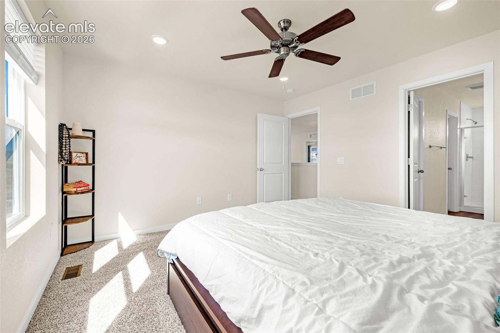 Light-colored walls with recessed lighting, brown ceiling fan, and carpeted flooring