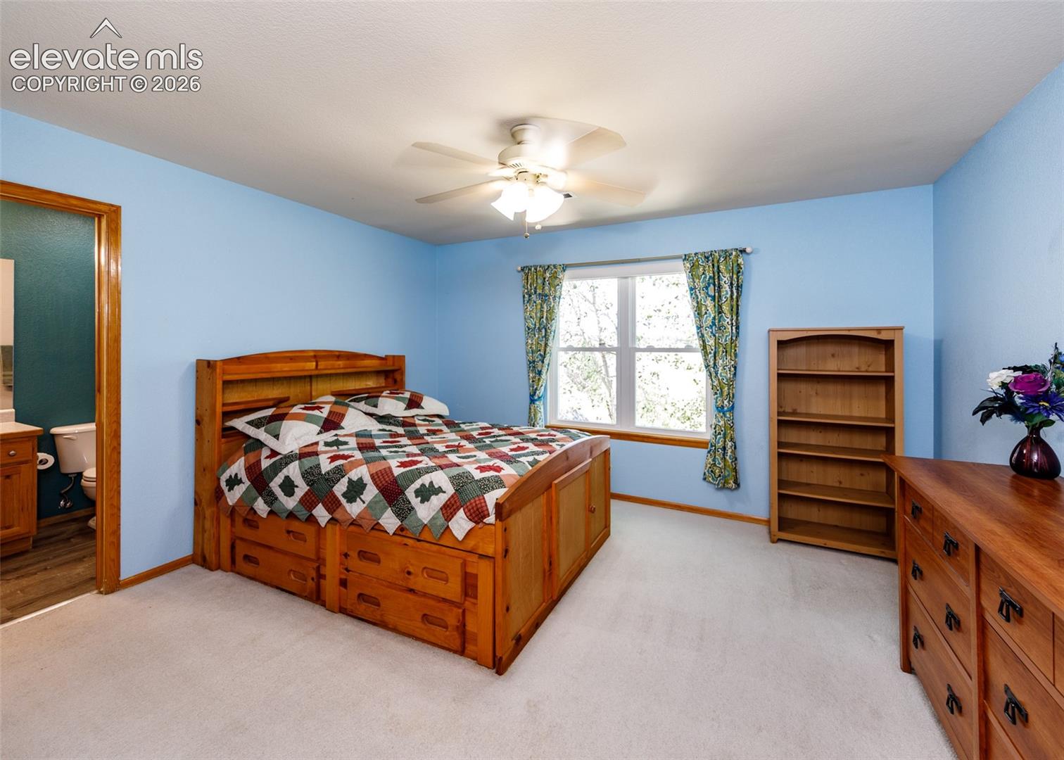 Room featuring wall-to-wall carpeting, a dual-pane window, and a central ceiling fan with integrated lighting