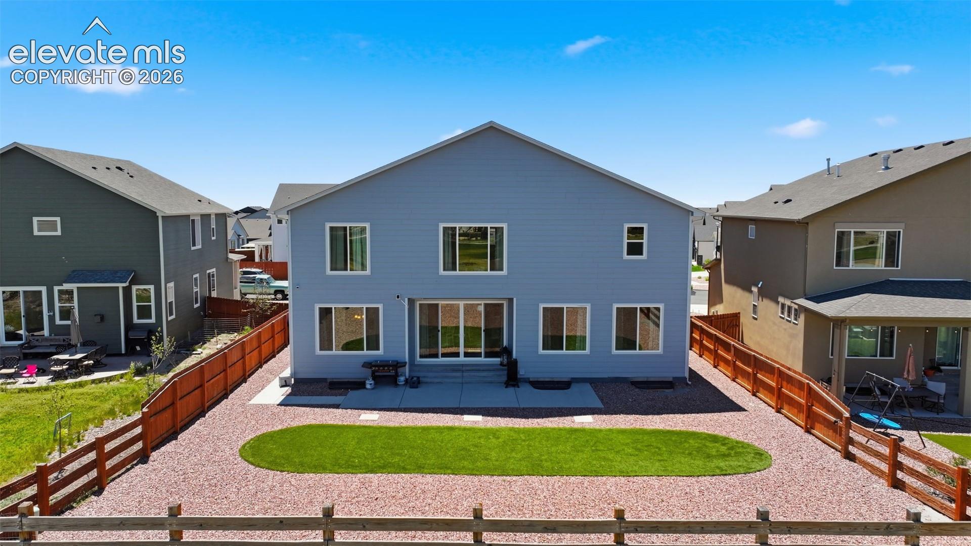 Landscaped, Fenced Backyard with Low-Maintenance Artificial Turf & Open-Space Setting