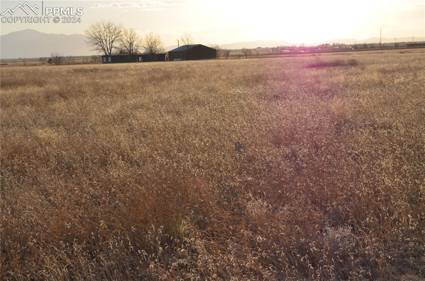 View of yard with a rural view and a mountain view