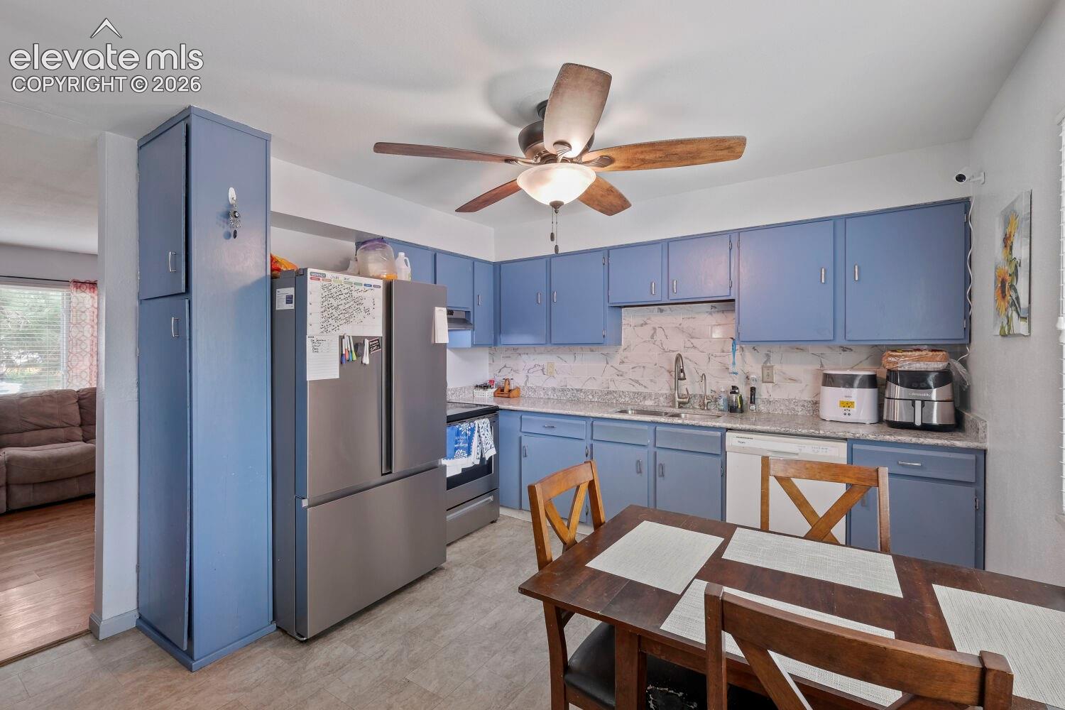 Kitchen featuring blue cabinetry, granite-look countertops, and a full suite of stainless steel appliances