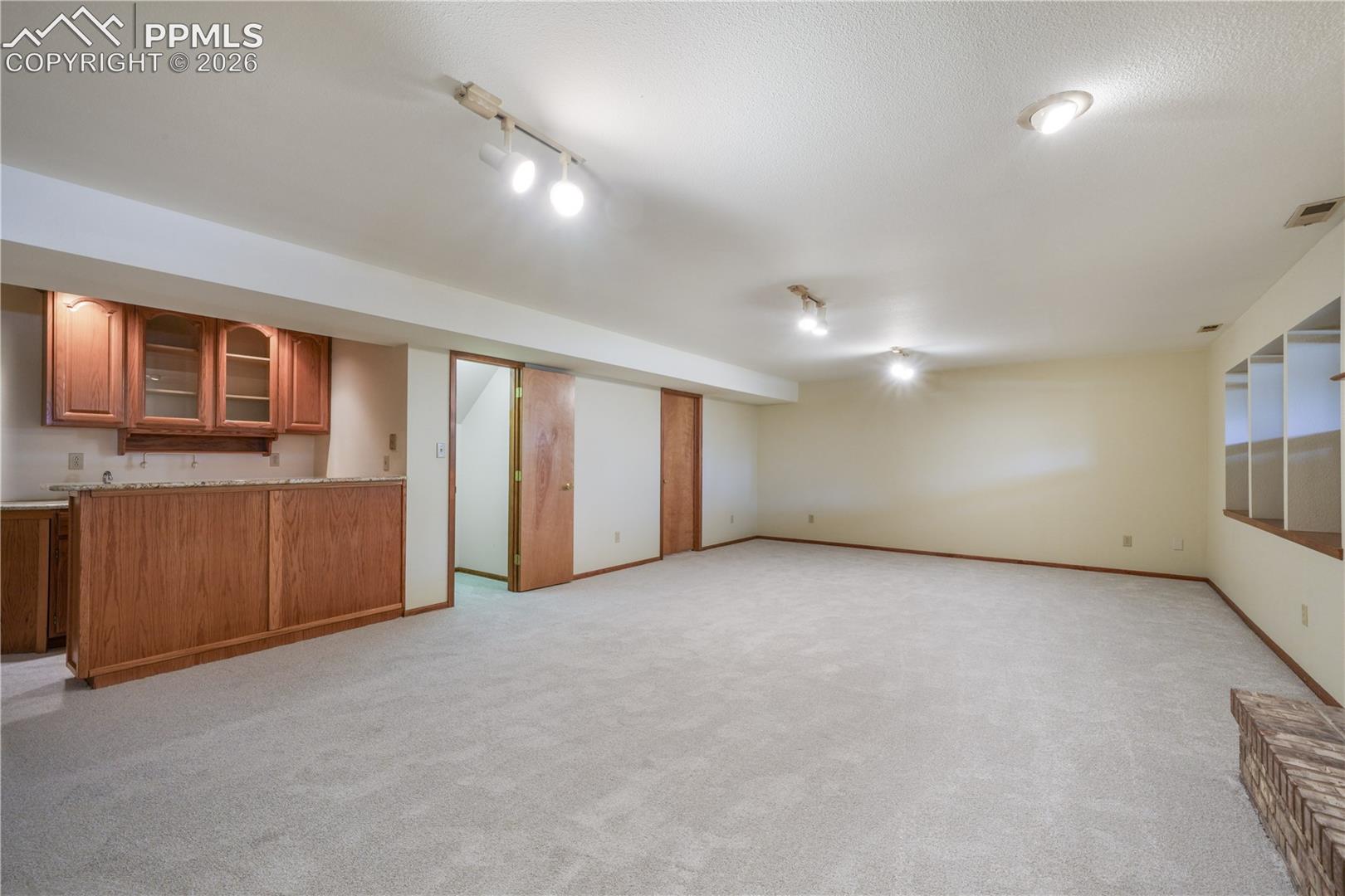 Basement family room, new carpet, views of storage room