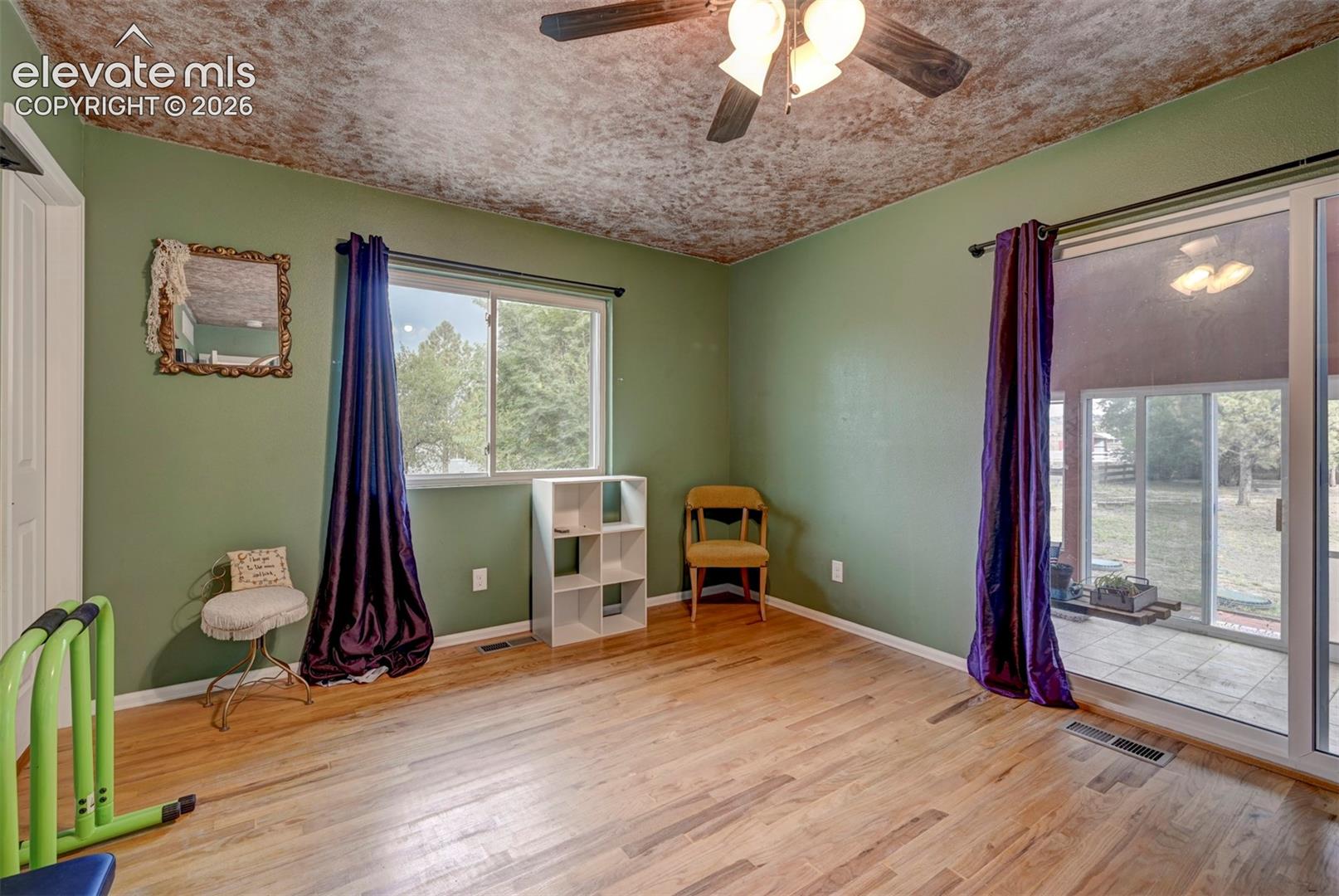 Wood-finish flooring with a ceiling fan light fixture