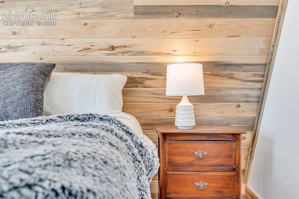 Natural wood-plank wall paneling with varied grain detailing and slanted architectural ceiling profile