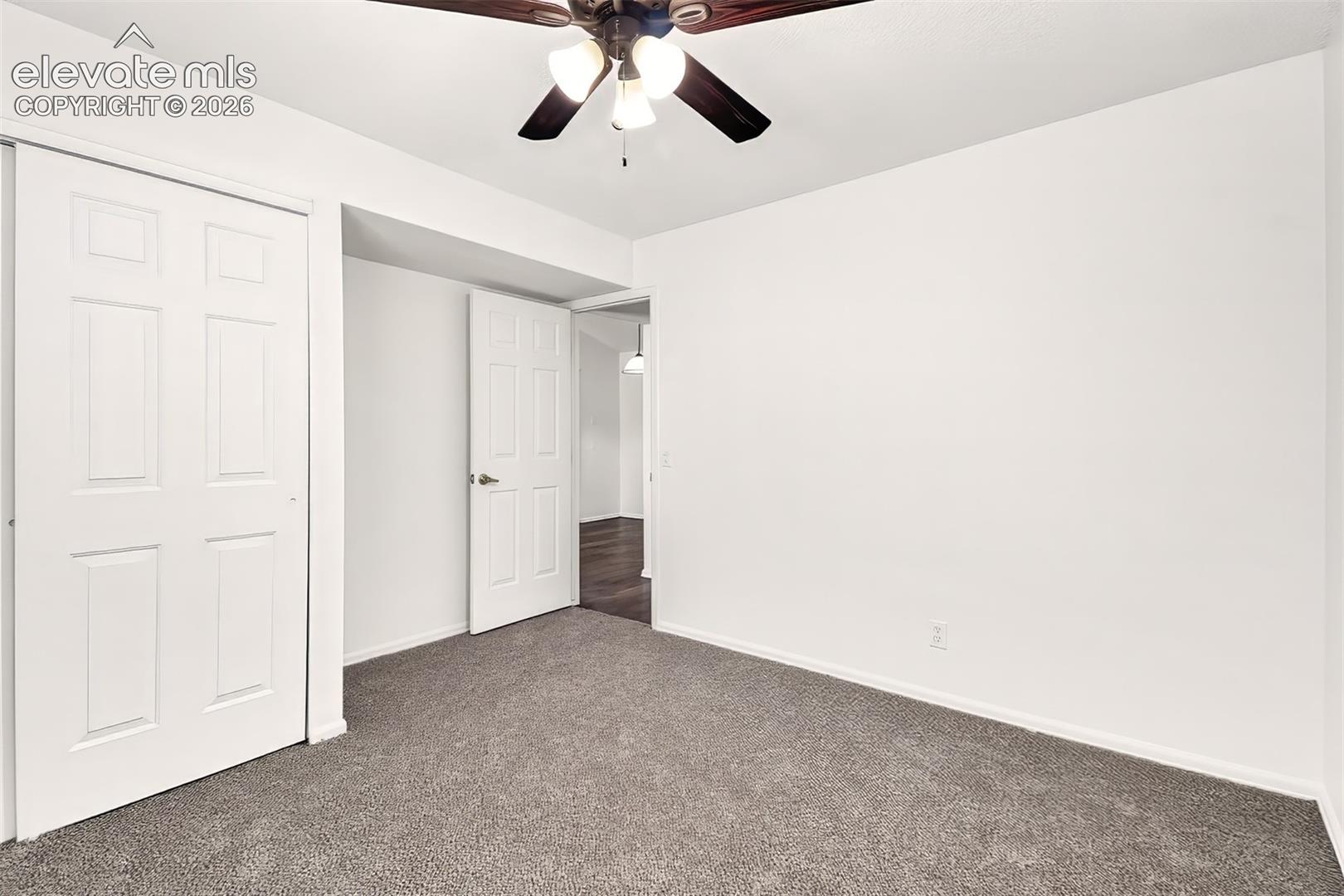 Secondary bedroom with new paint and new carpet.