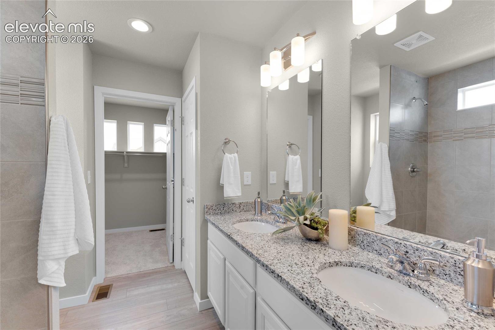 Dual vanity with granite countertop, individual sinks, and chrome fixtures
*photos of a model home*
