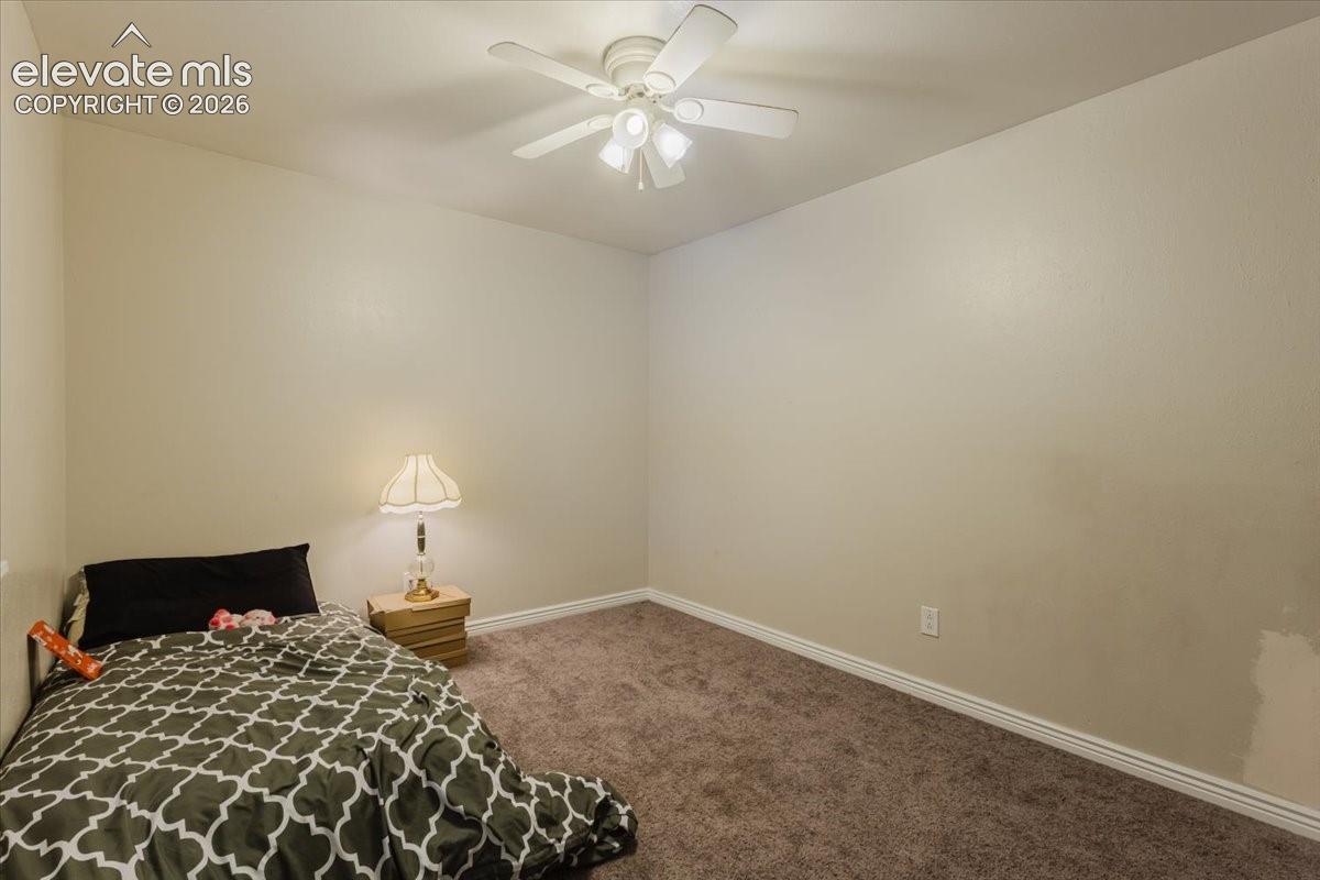 Neutral tone walls with white trim and a ceiling fan with integrated lighting