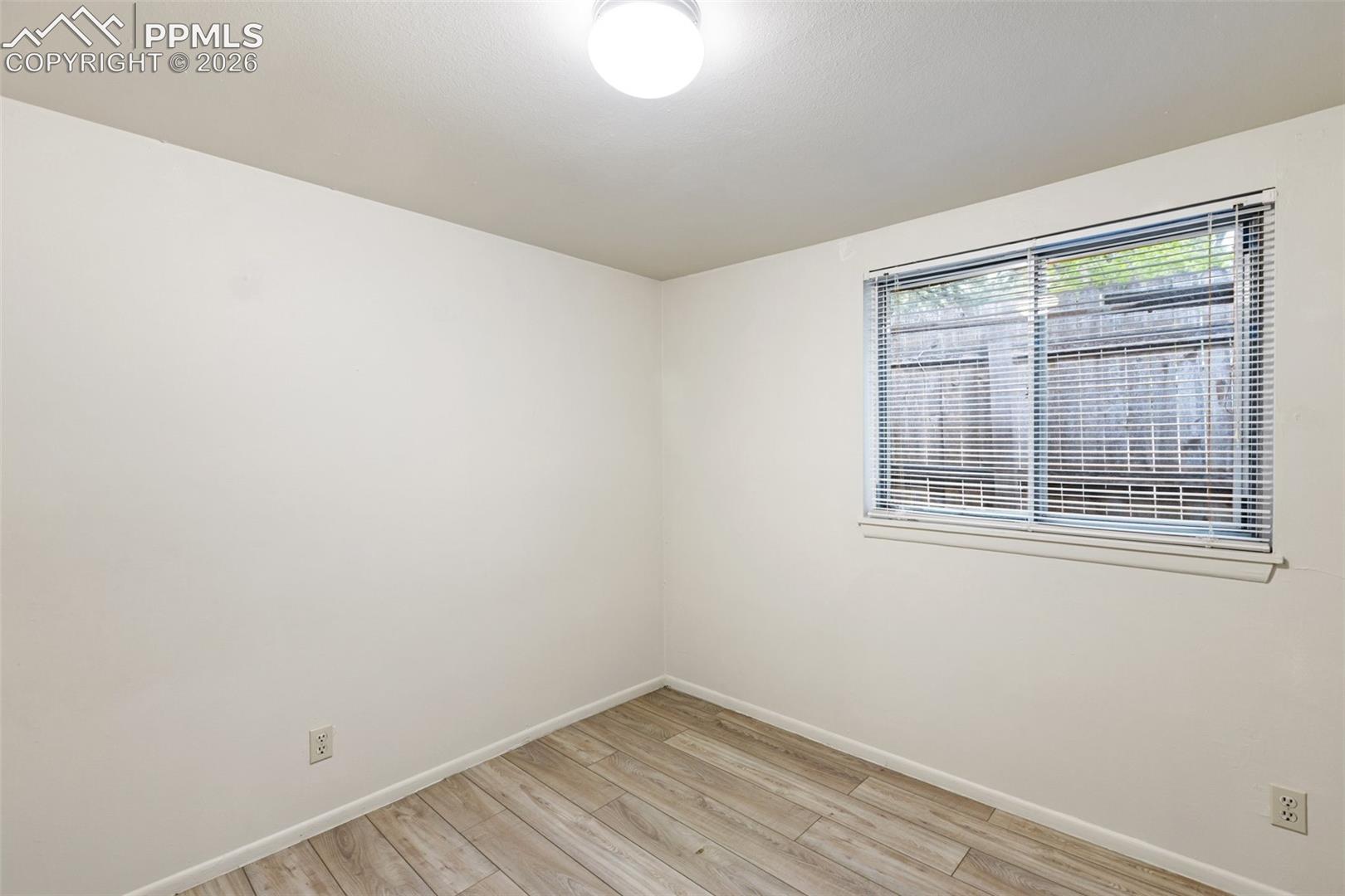 One of 2 bedrooms - features LVP flooring for easy maintenance.