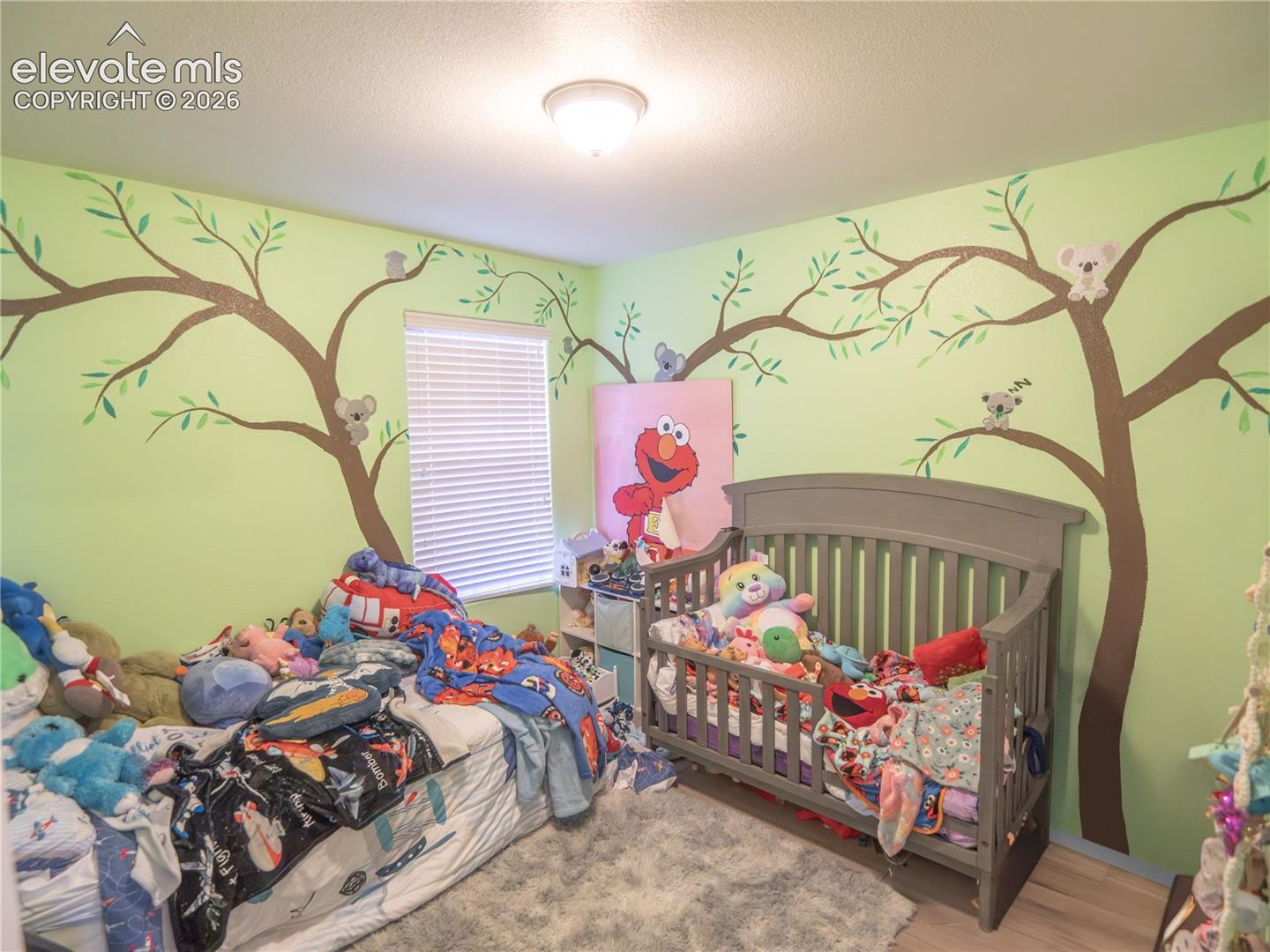 Carpeted room with vaulted ceiling and neutral wall paint