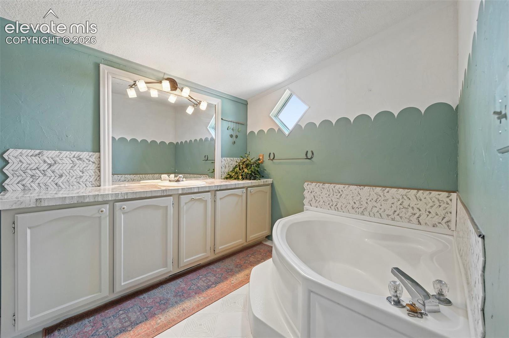 Boast Stencil Tile Flooring, Garden Soaking Tub and Stand Alone Shower!
