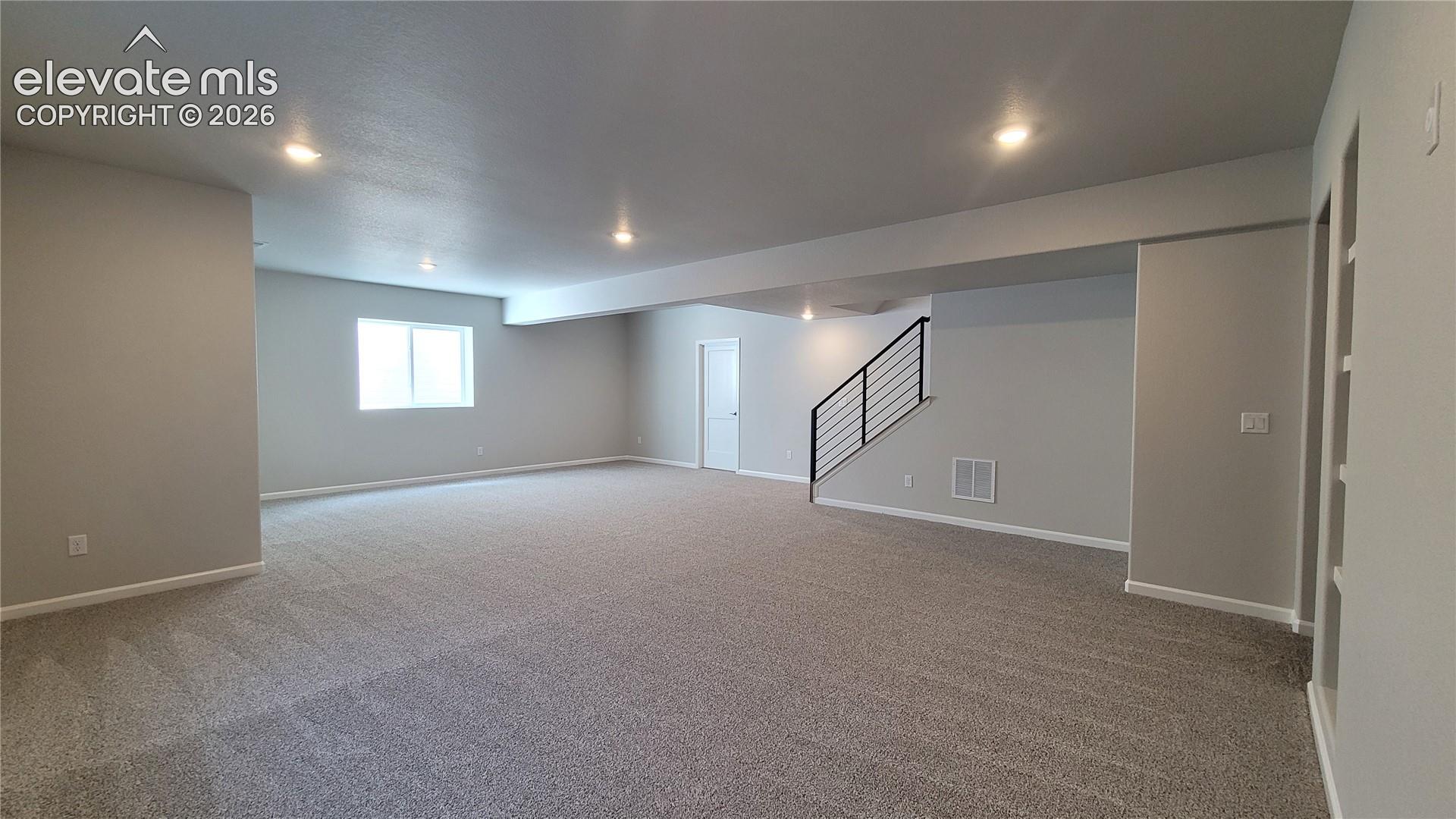 Finished Basement with 9' Ceilings boasts a spacious family room with built-in shelving and game area prepped for a future wet bar!