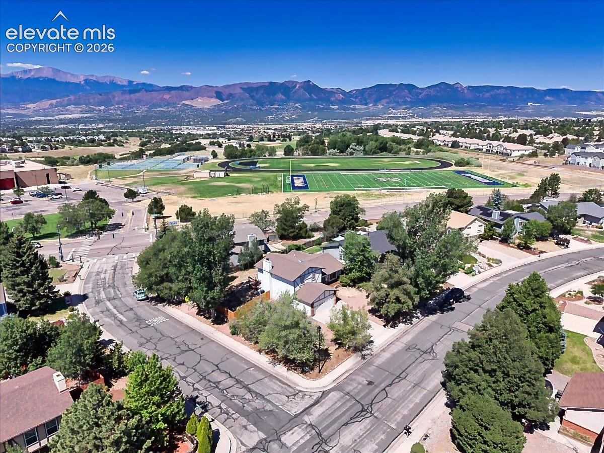 Aerial perspective highlighting the home's proximity to nearby parks, athletic fields, and breathtaking mountain scenery.