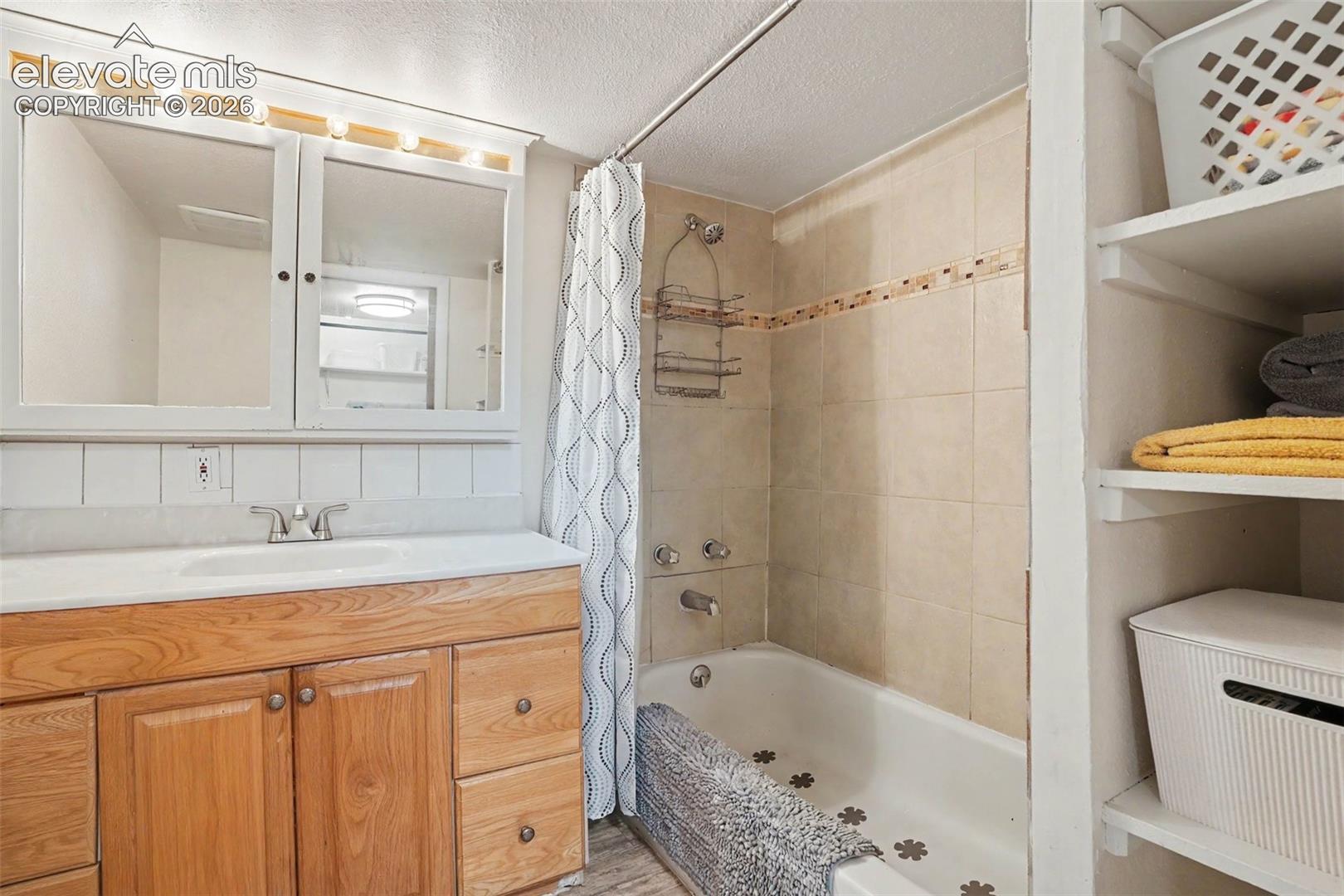 Decorative tile accent in shower in this private bathroom next to the master.