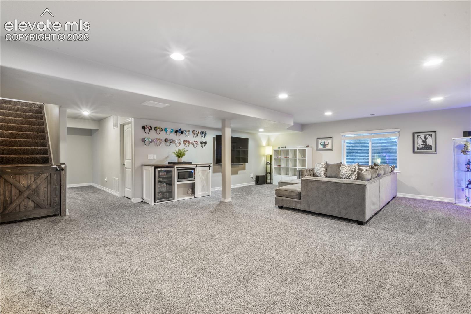 Finished lower level featuring recessed lighting, a built-in wet bar, and carpeting