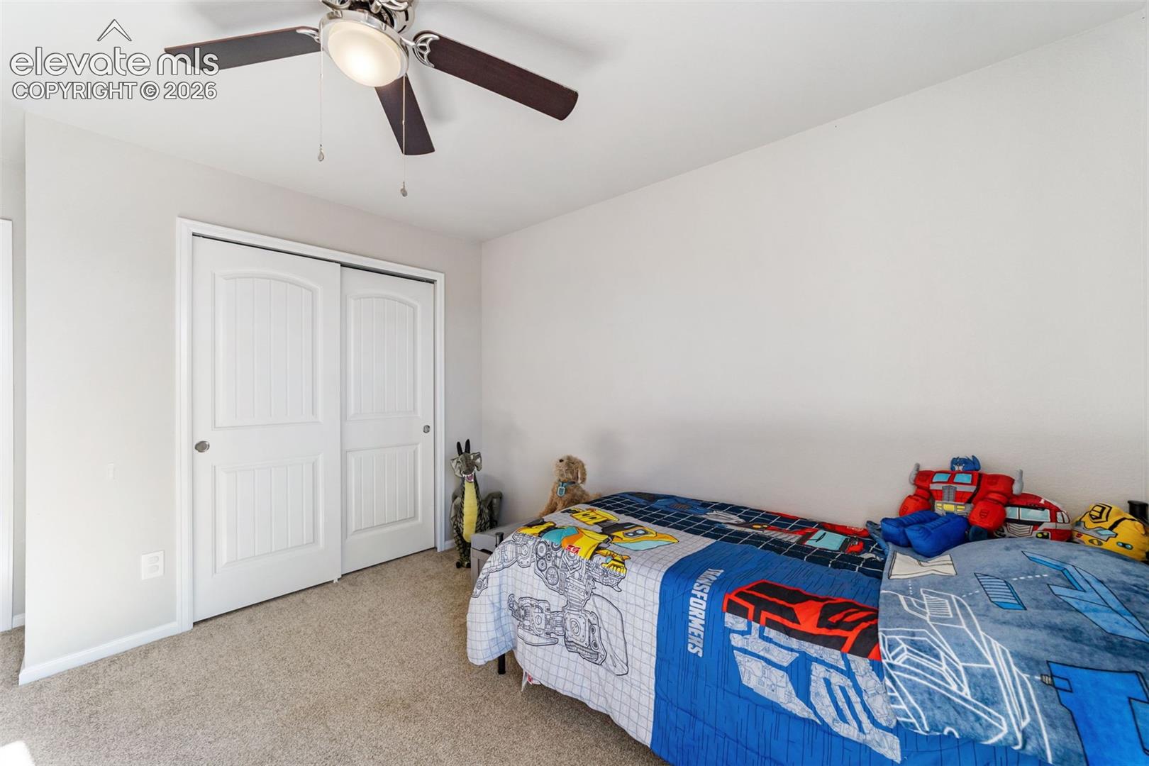Comfortable 3rd bedroom with closet storage and flexible use.