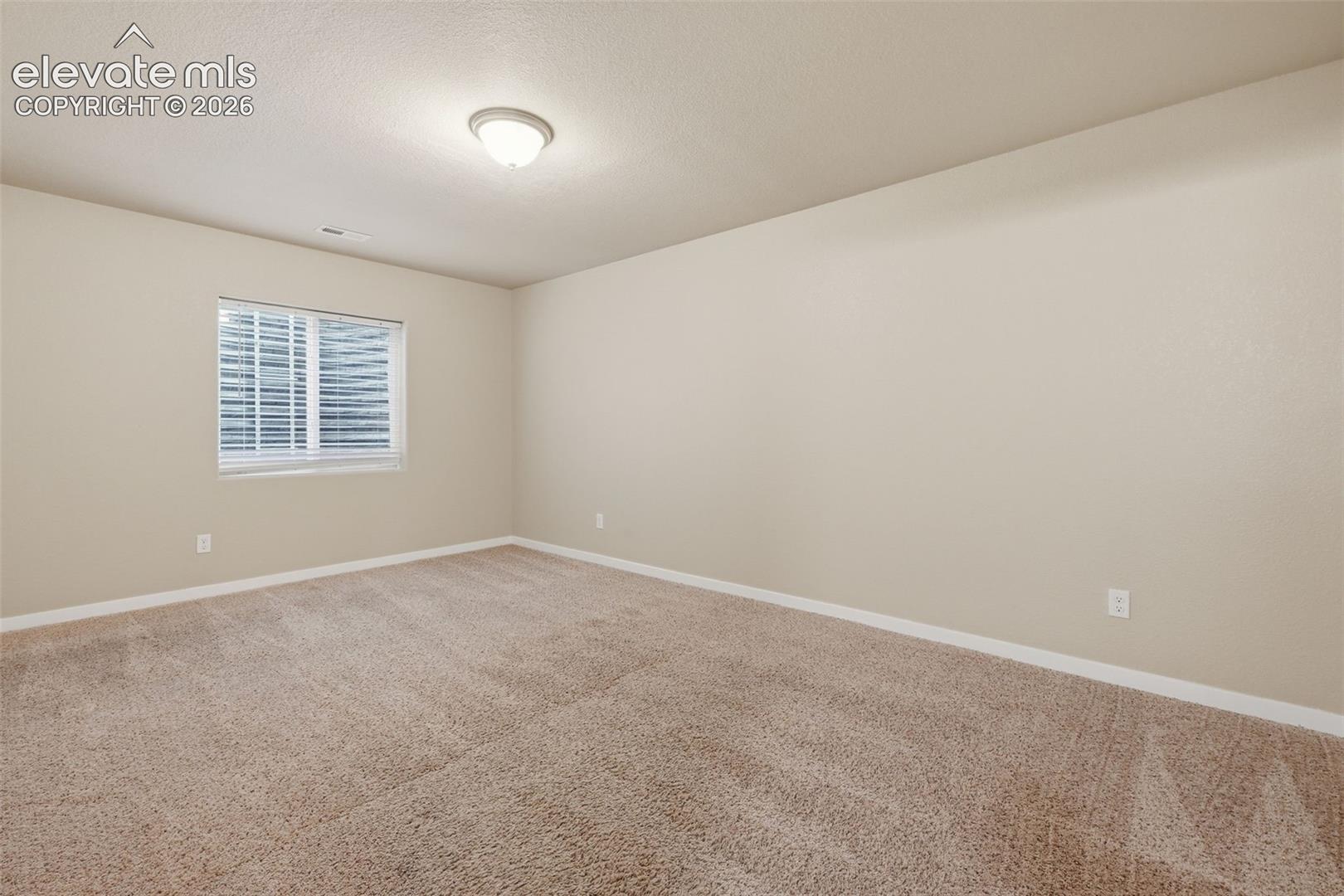 The fifth bedroom is located in the finished basement, creating separation for guests or another private living space.