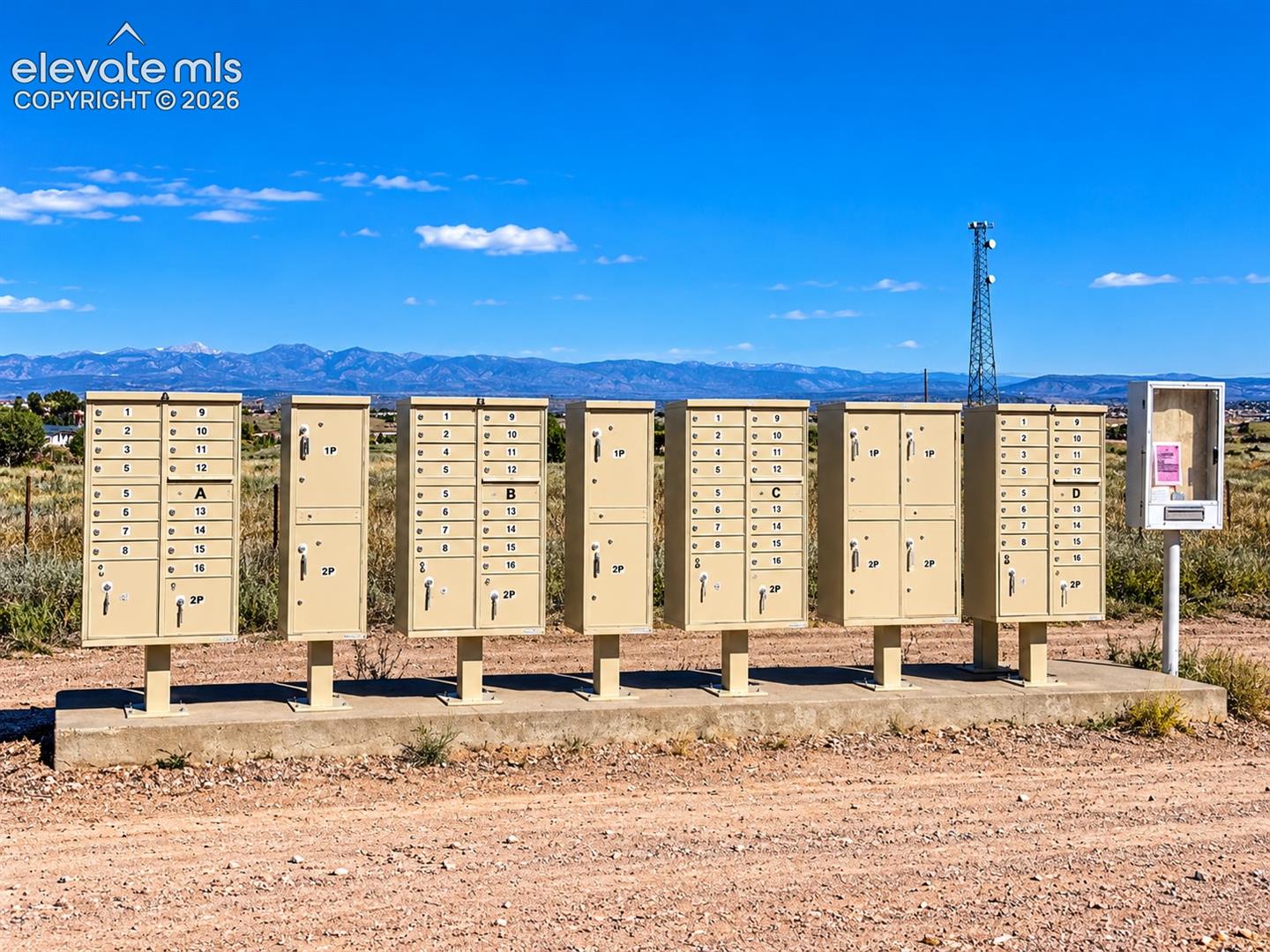 Convenient community cluster mailboxes serve Red Creek Ranch residents, with beautiful mountain views providing a scenic backdrop to this peaceful rural neighborhood.